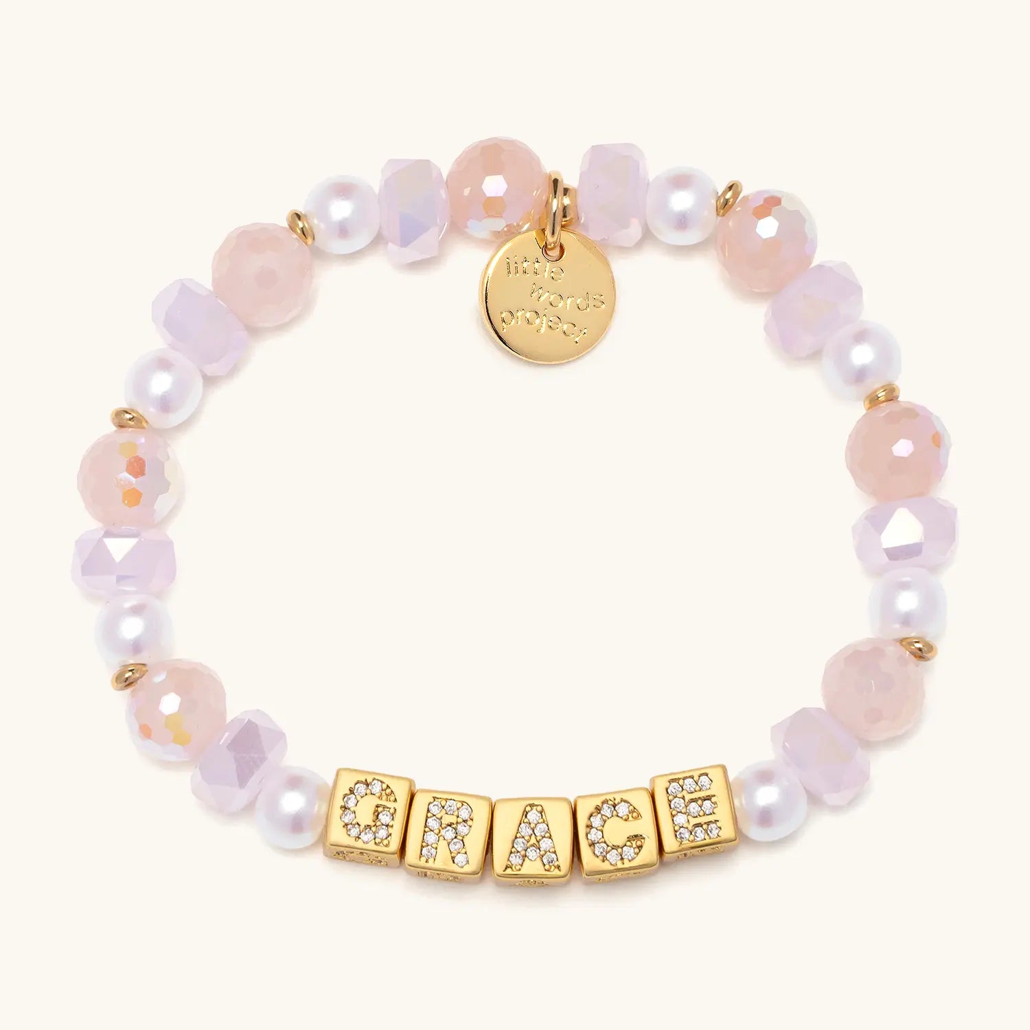 Bracelet with pink and white beads and gold letters on a white background