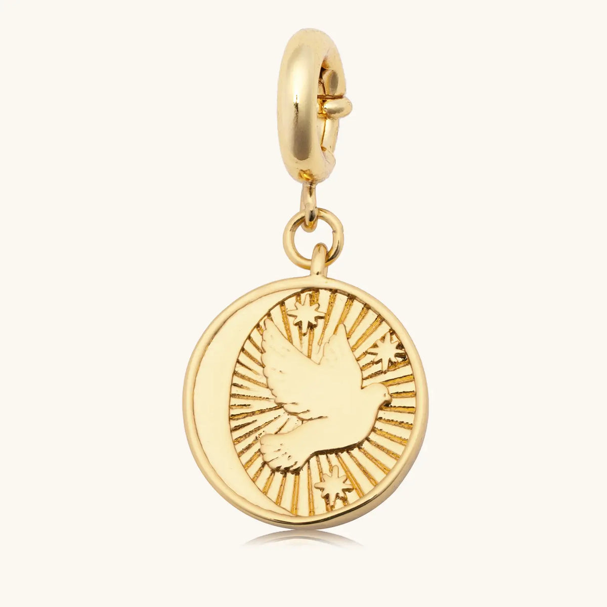 Prioritize Your Peace Charm back, 18k gold-plated round medallion with a dove in flight and stars on a gold spring ring clasp, detail on cream background