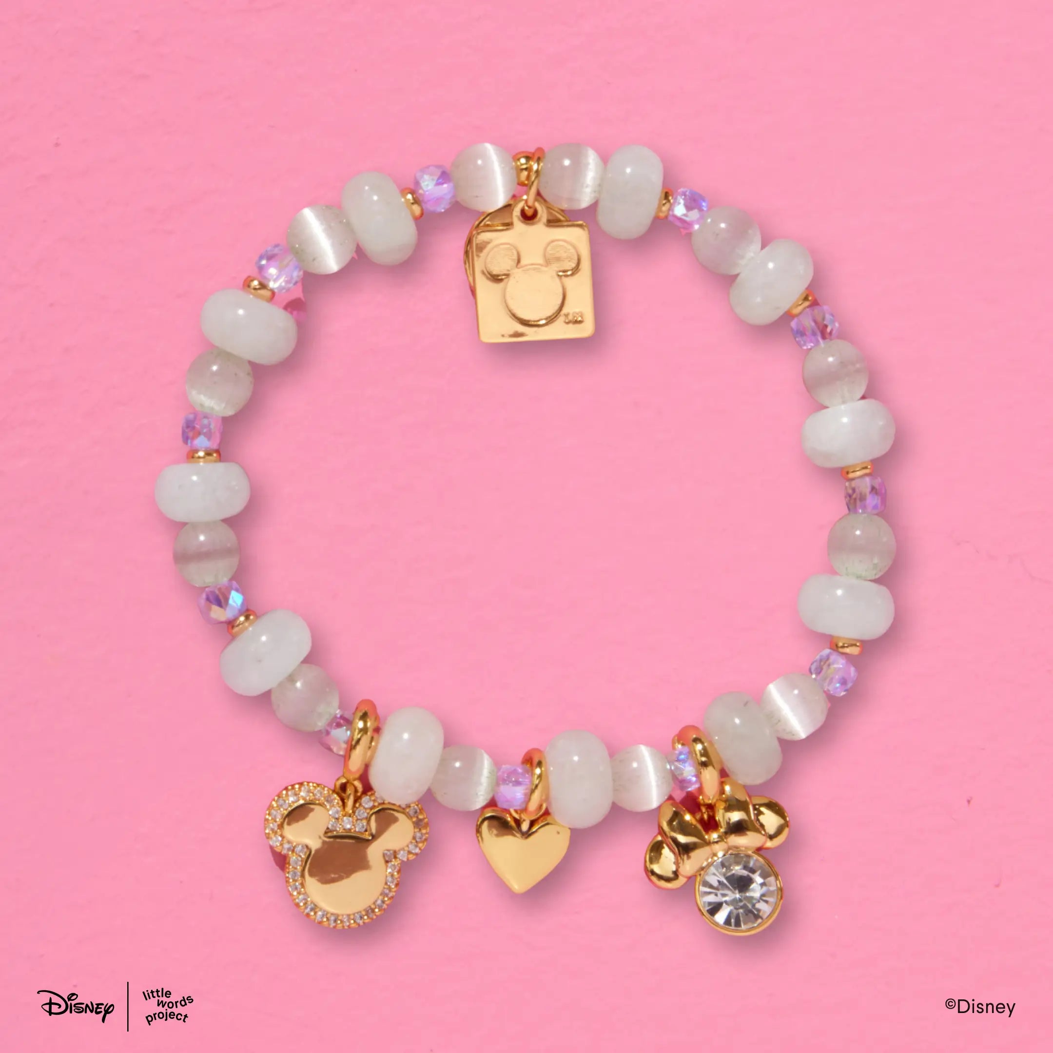 Mickey Mouse and Minnie Mouse Charm Bracelet from Disney Mickey and Friends flat lay on pink with mint green beads and gold plated Mickey Mouse, Minnie Mouse, heart and crystal charms
