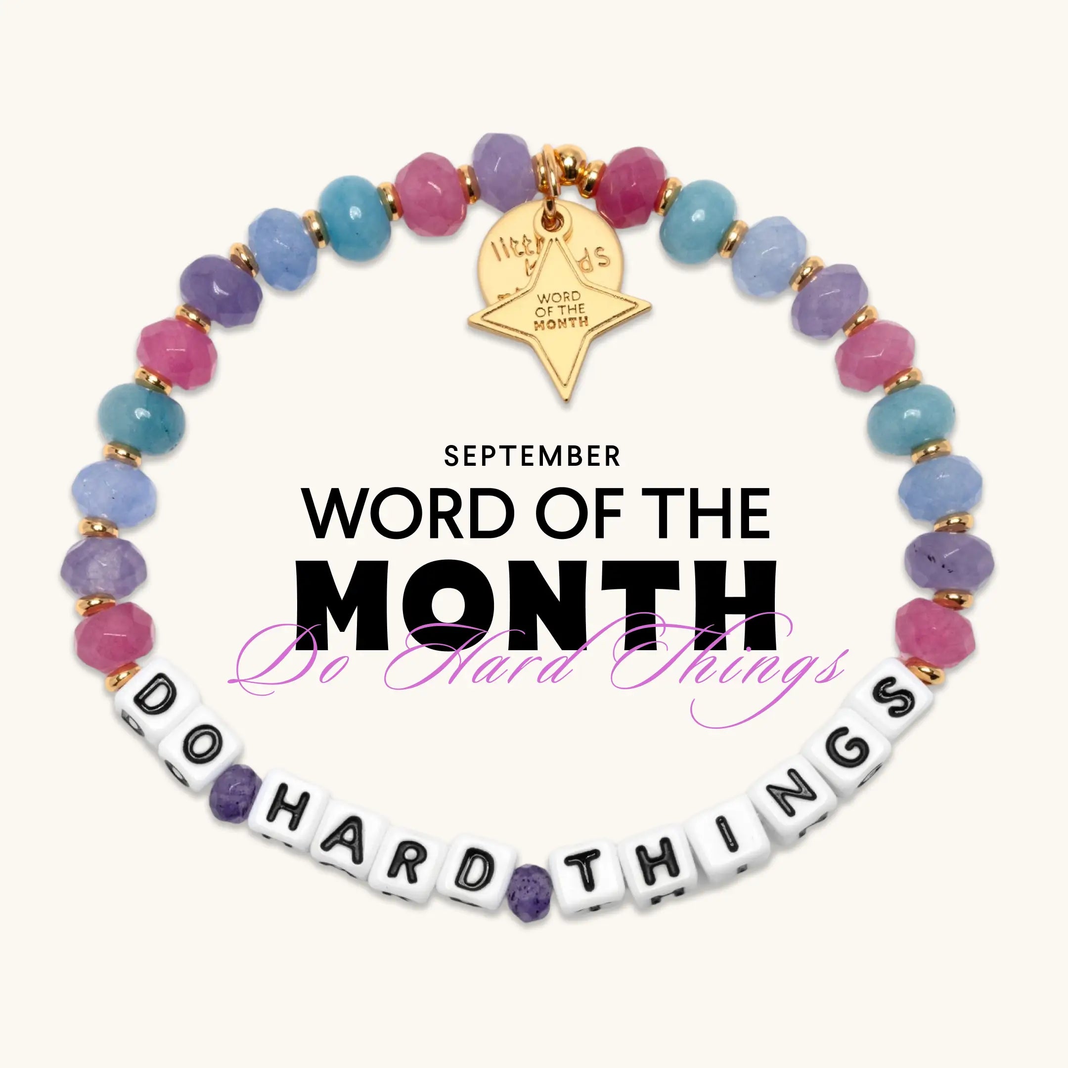 Do Hard Things September Word of the Month bracelet with white letter beads, pink, purple and blue faceted beads, and a gold Word of the Month star charm