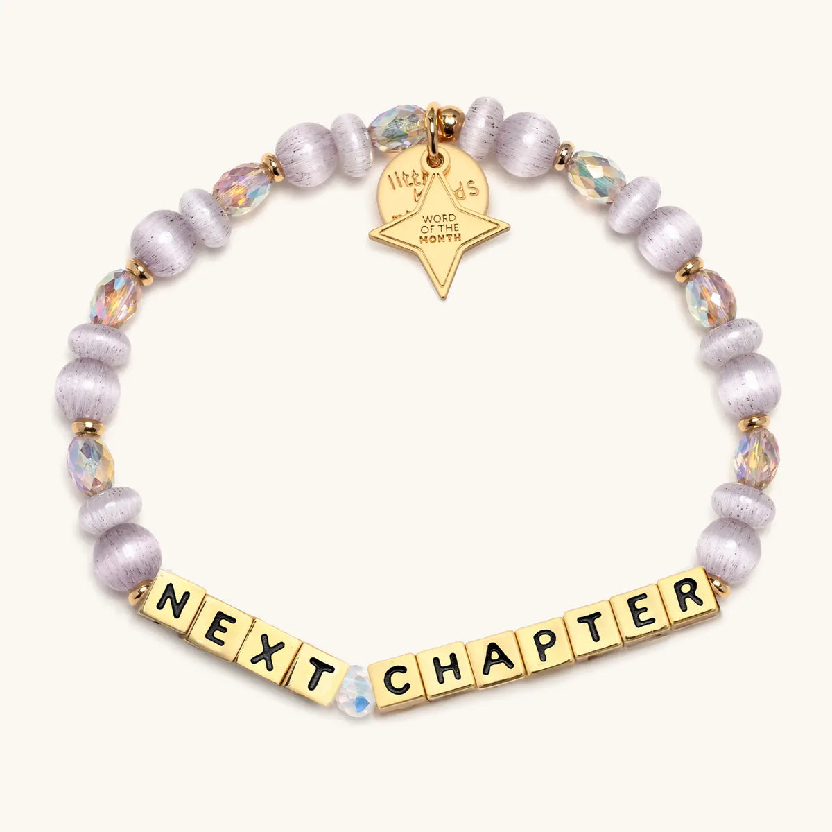 Next Chapter bracelet with gold letter beads and a gold tag, from the Six Months of Intention set
