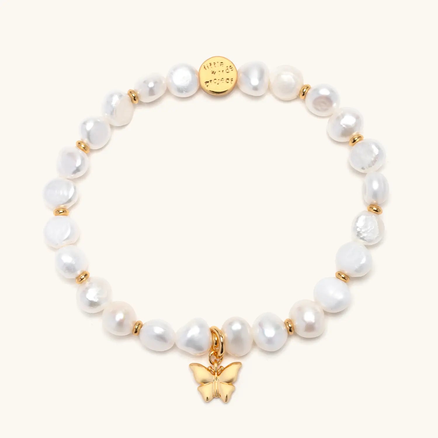 Butterfly Pearl Bracelet Base- Nika Diwa flat-lay, freshwater pearl beads with gold rondelle spacers and gold plated brass butterfly charm