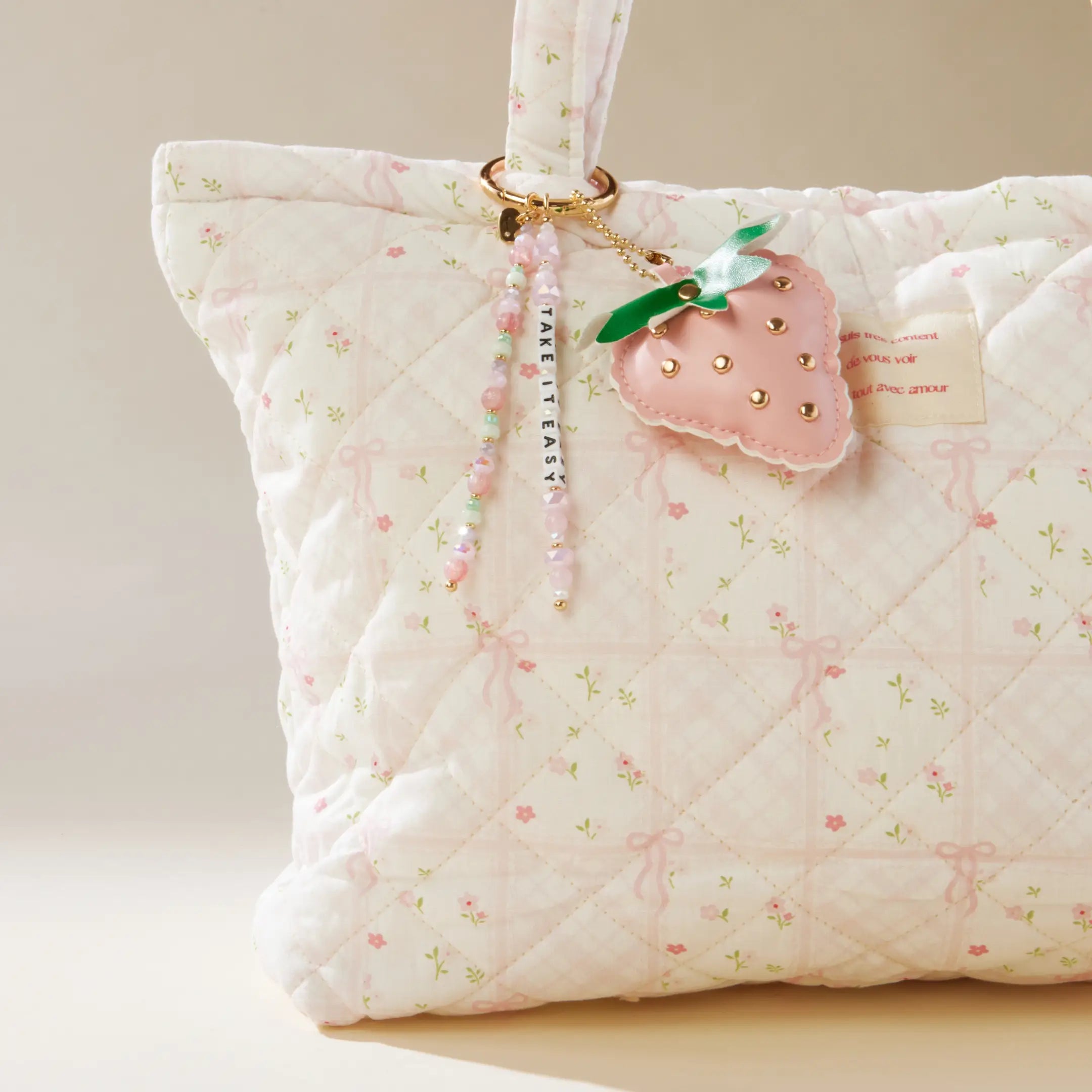 Take It Easy Strawberry Bag Charm lifestyle flat lay