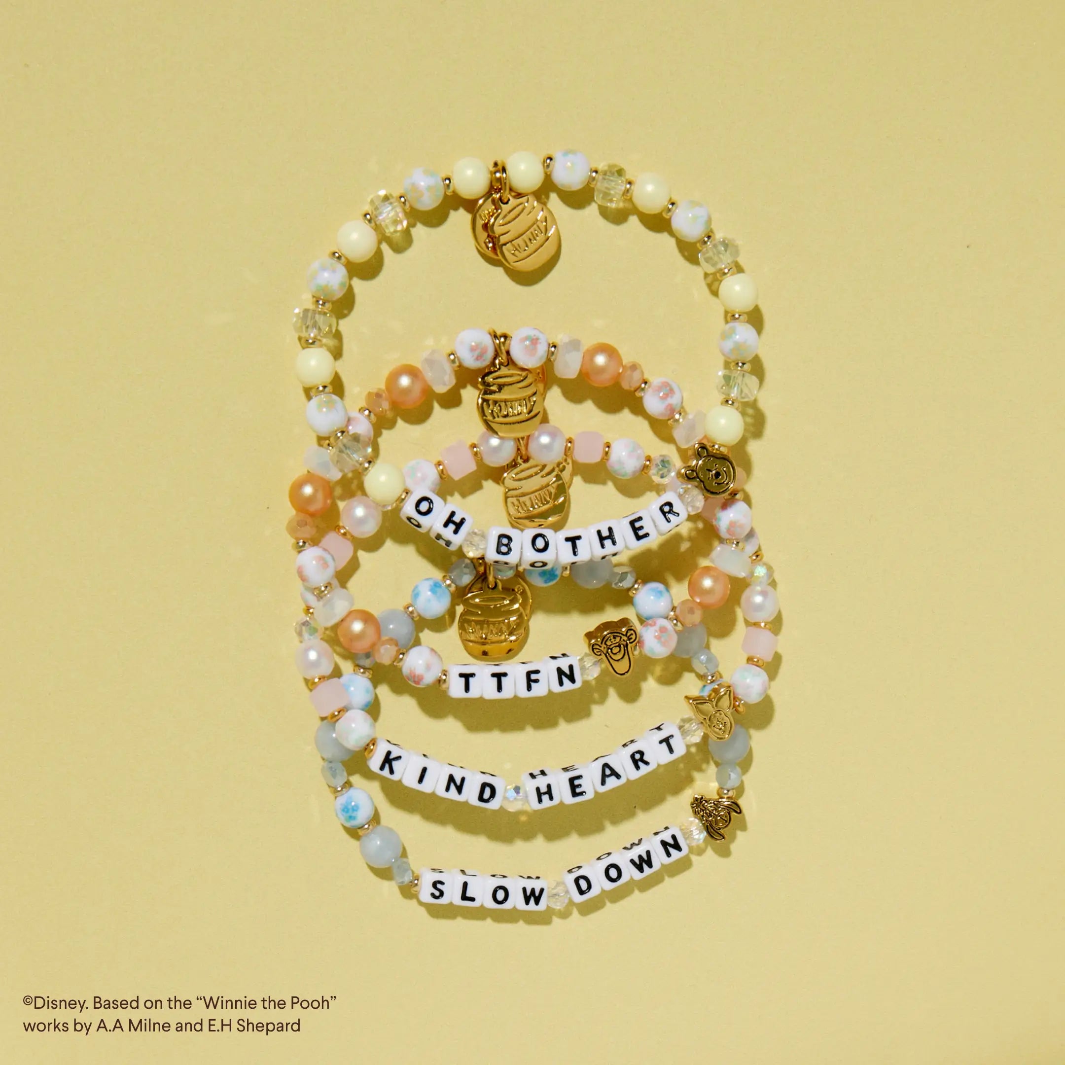 Set of beaded bracelets on a yellow background