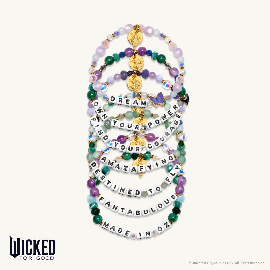 Stack of colorful beaded bracelets with inspirational charms on a white background, featuring the brand 'Wicked for Good'.