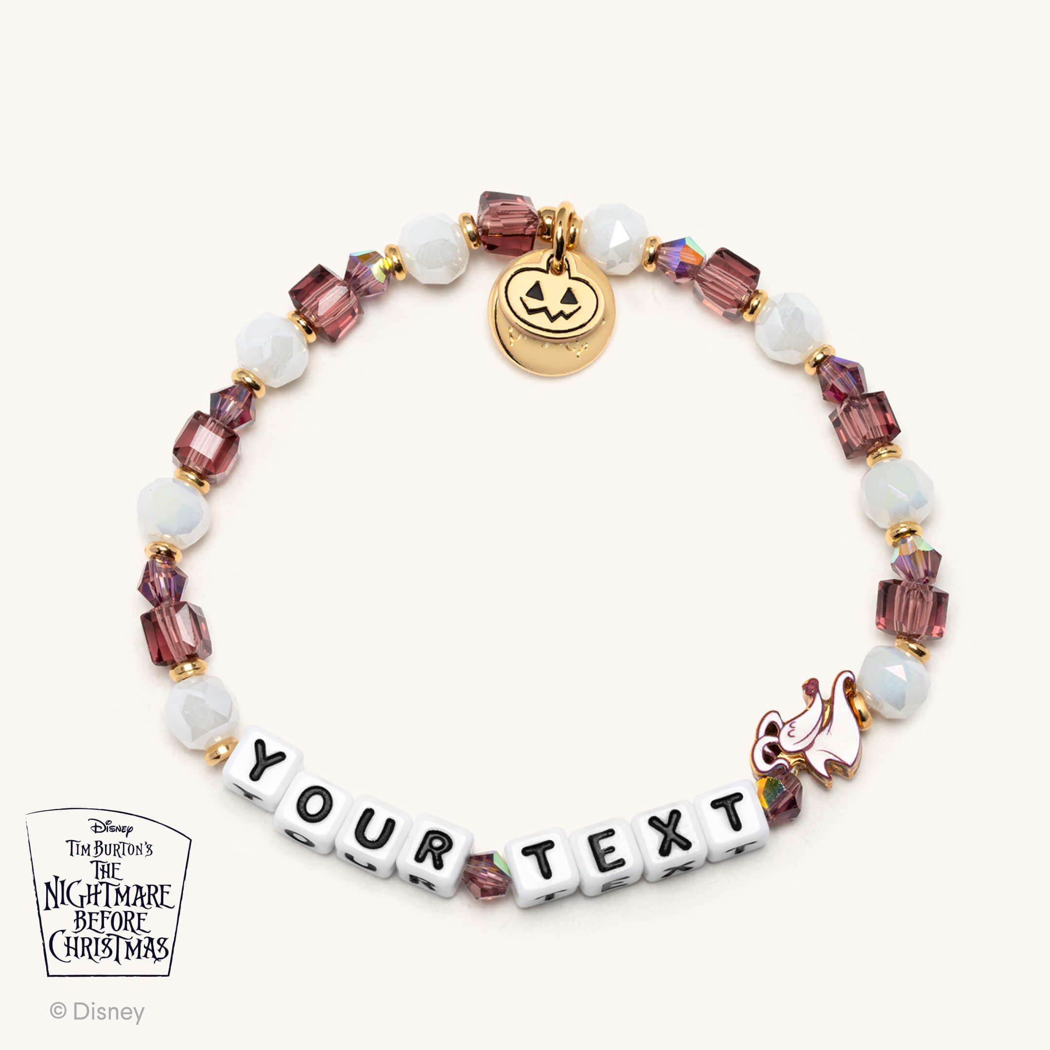 Bracelet with customizable text charm and Disney character charms on a white background
