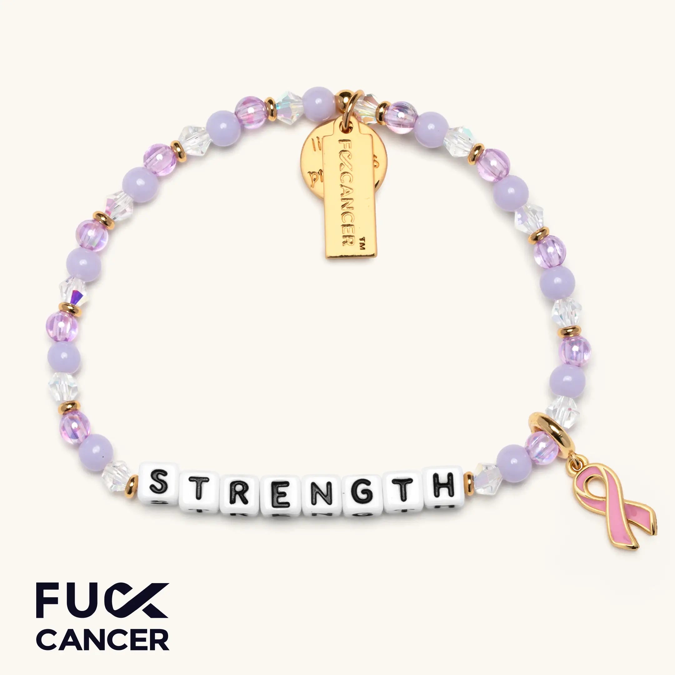 Bracelet with 'STRENGTH', pink ribbon charm, and gold tag on a white background