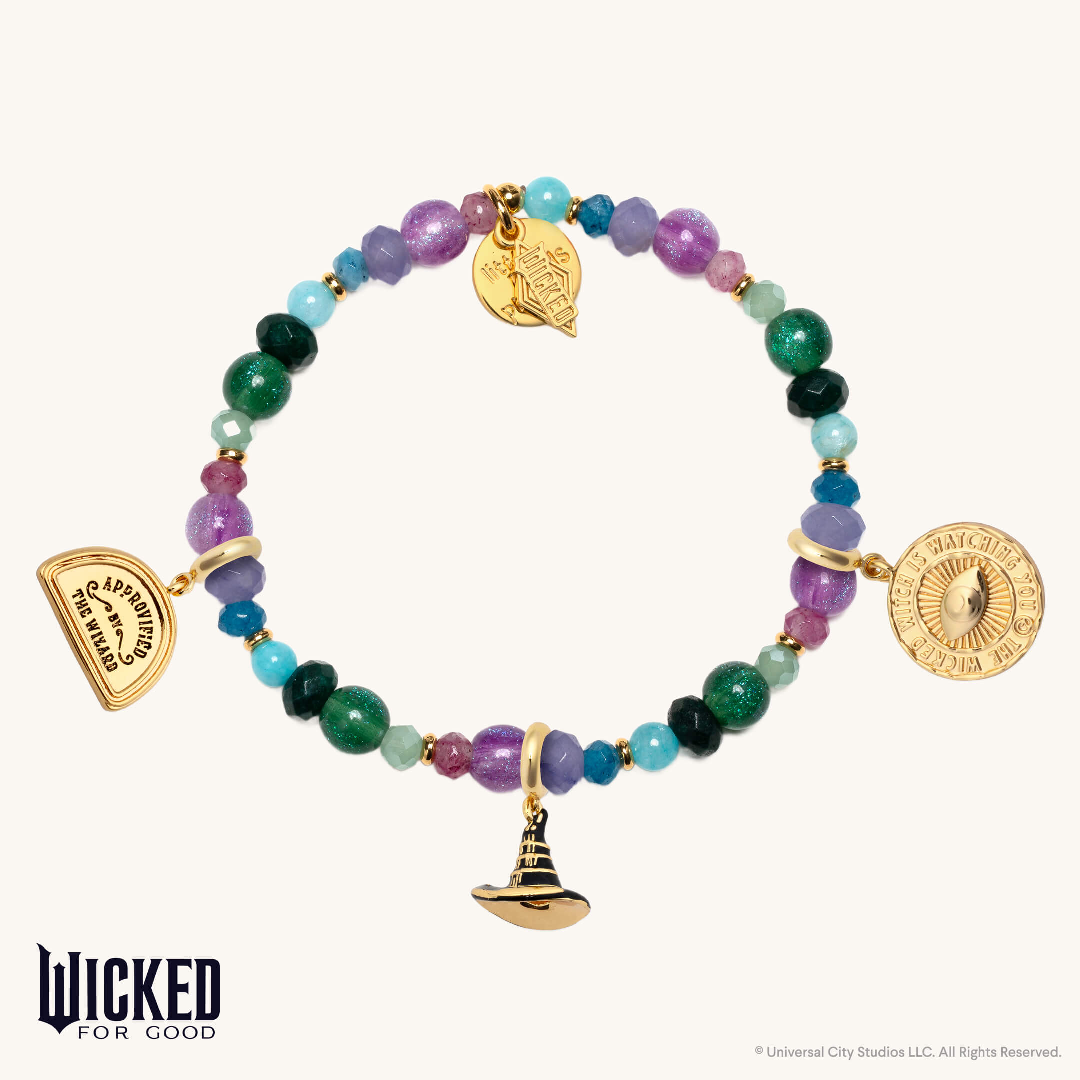 Colorful beaded bracelet with gold charms on a white background, featuring the 'Wicked for Good' brand.