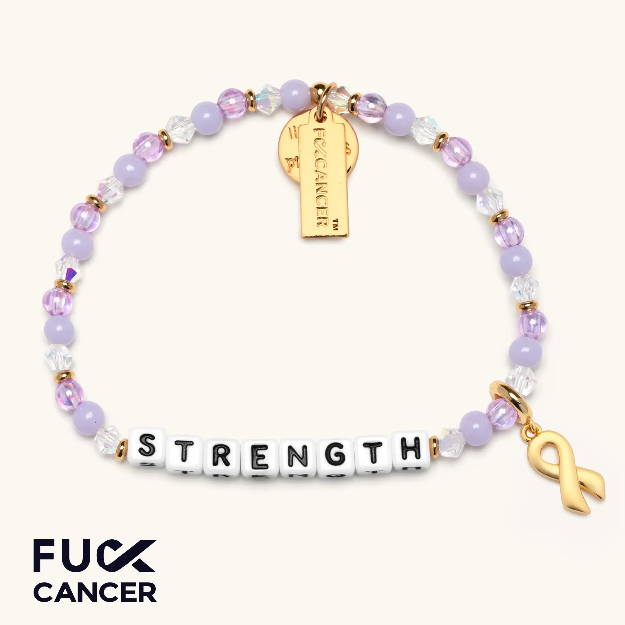 Bracelet with 'STRENGTH', gold ribbon charm, and gold tag on a white background