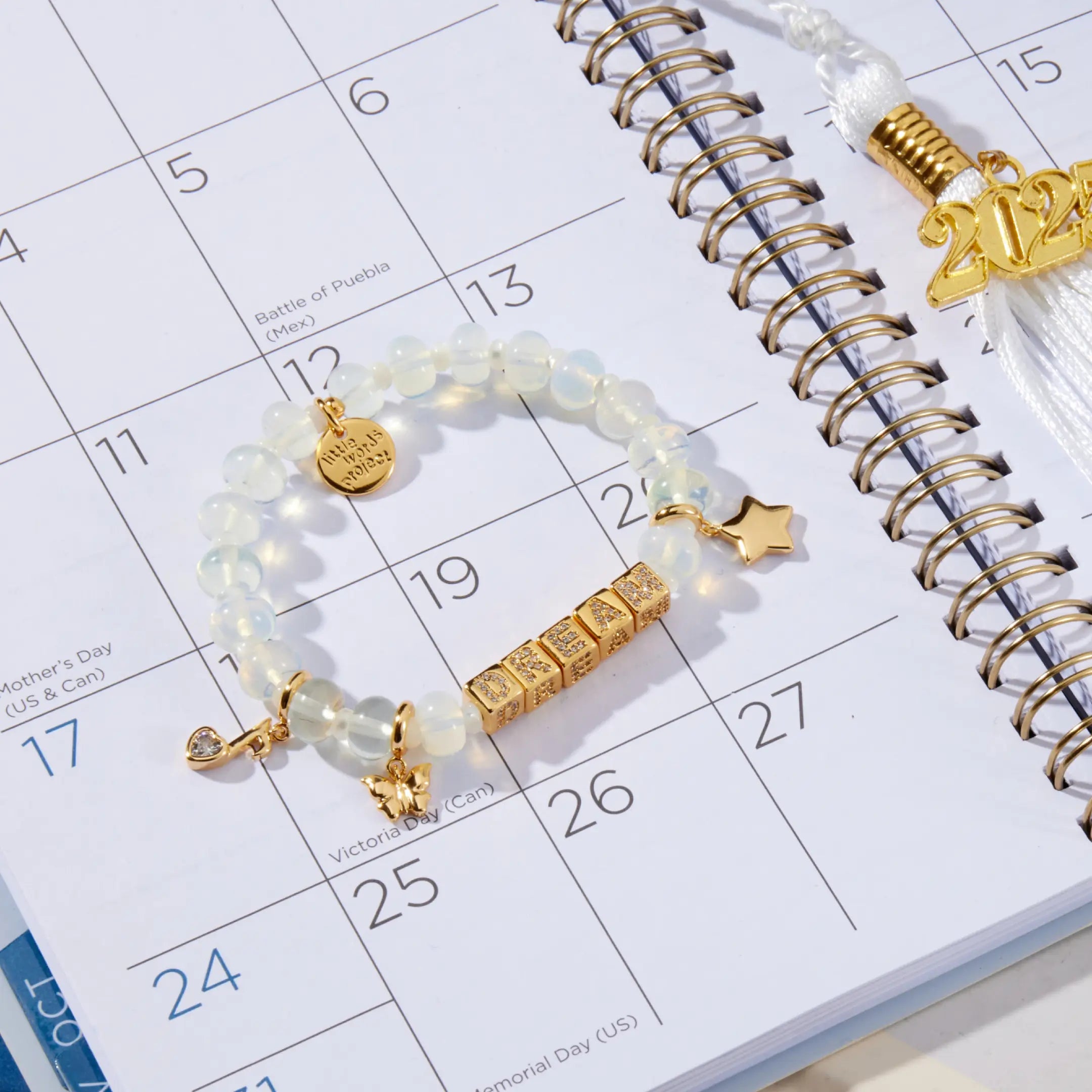 Gold and white beaded bracelet on a calendar