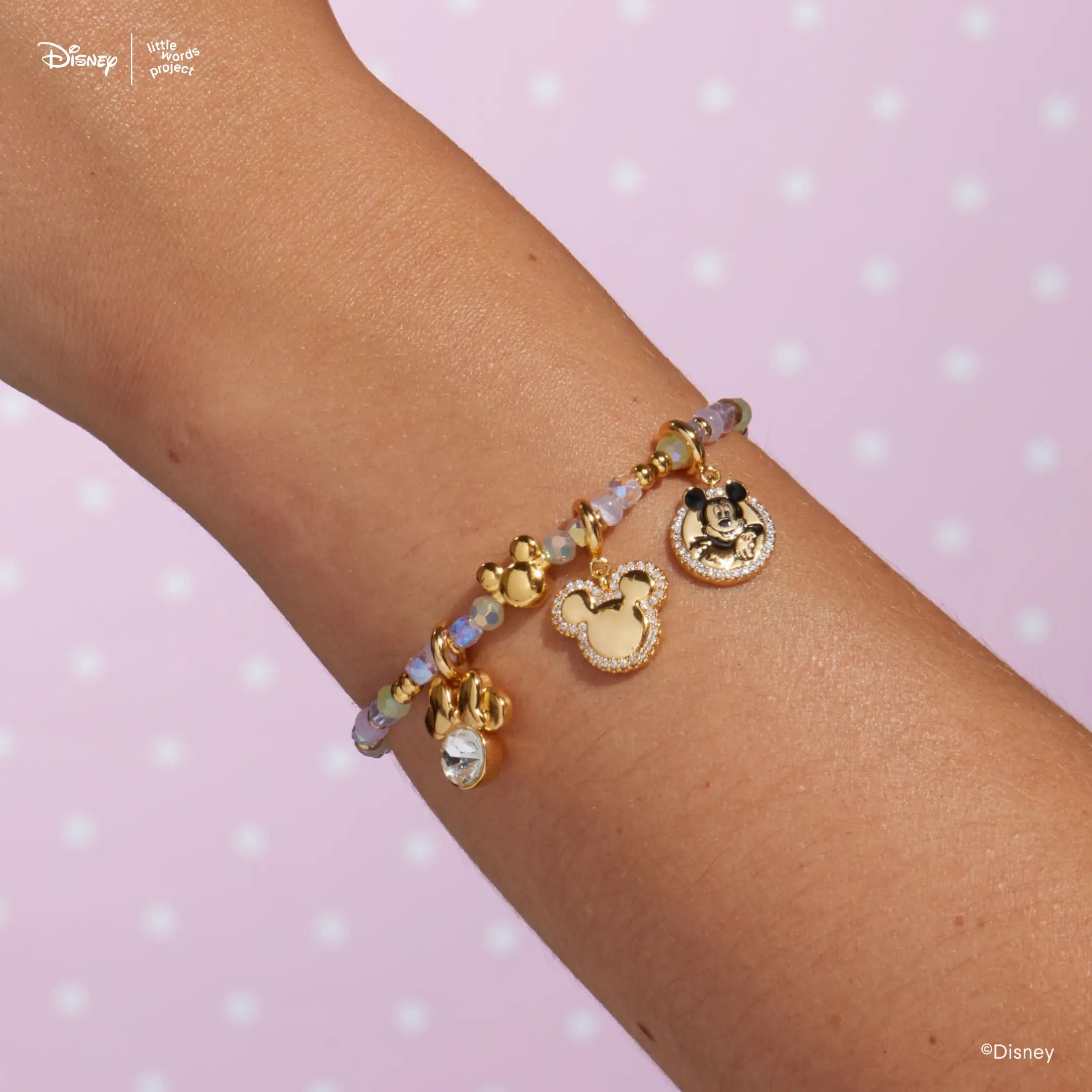 Disney Mickey and Friends beaded bracelet worn on a wrist, styled with gold plated Mickey Mouse and Minnie Mouse charms