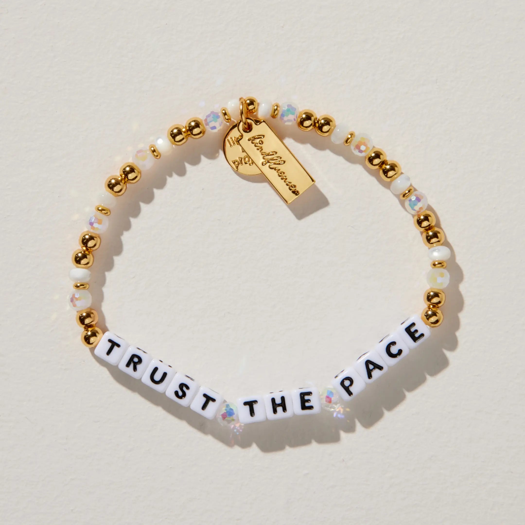 Bracelet with 'Trust the Pace' message on a light background
