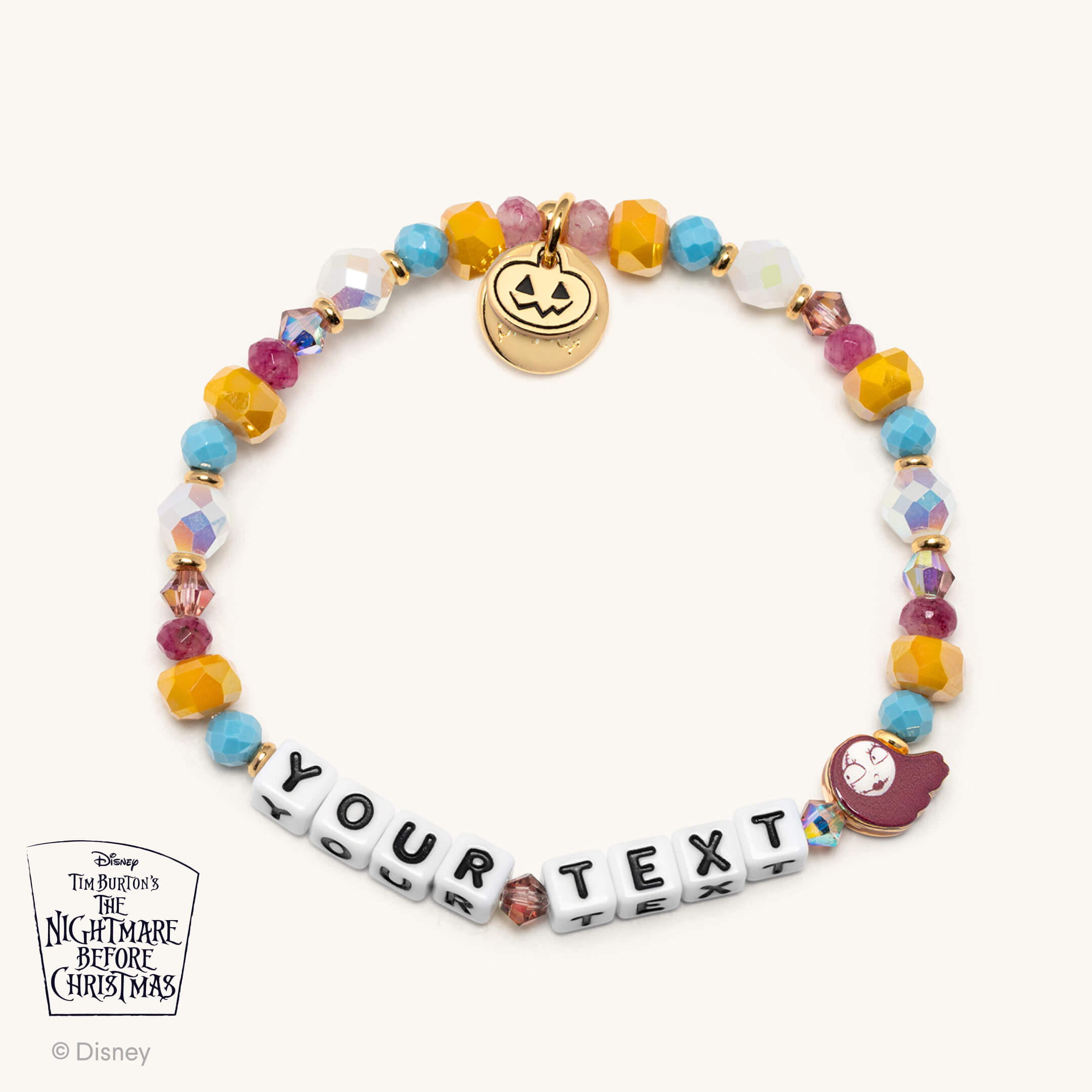 Colorful beaded bracelet with text charms and Halloween-themed charms on a white background, featuring Disney branding.