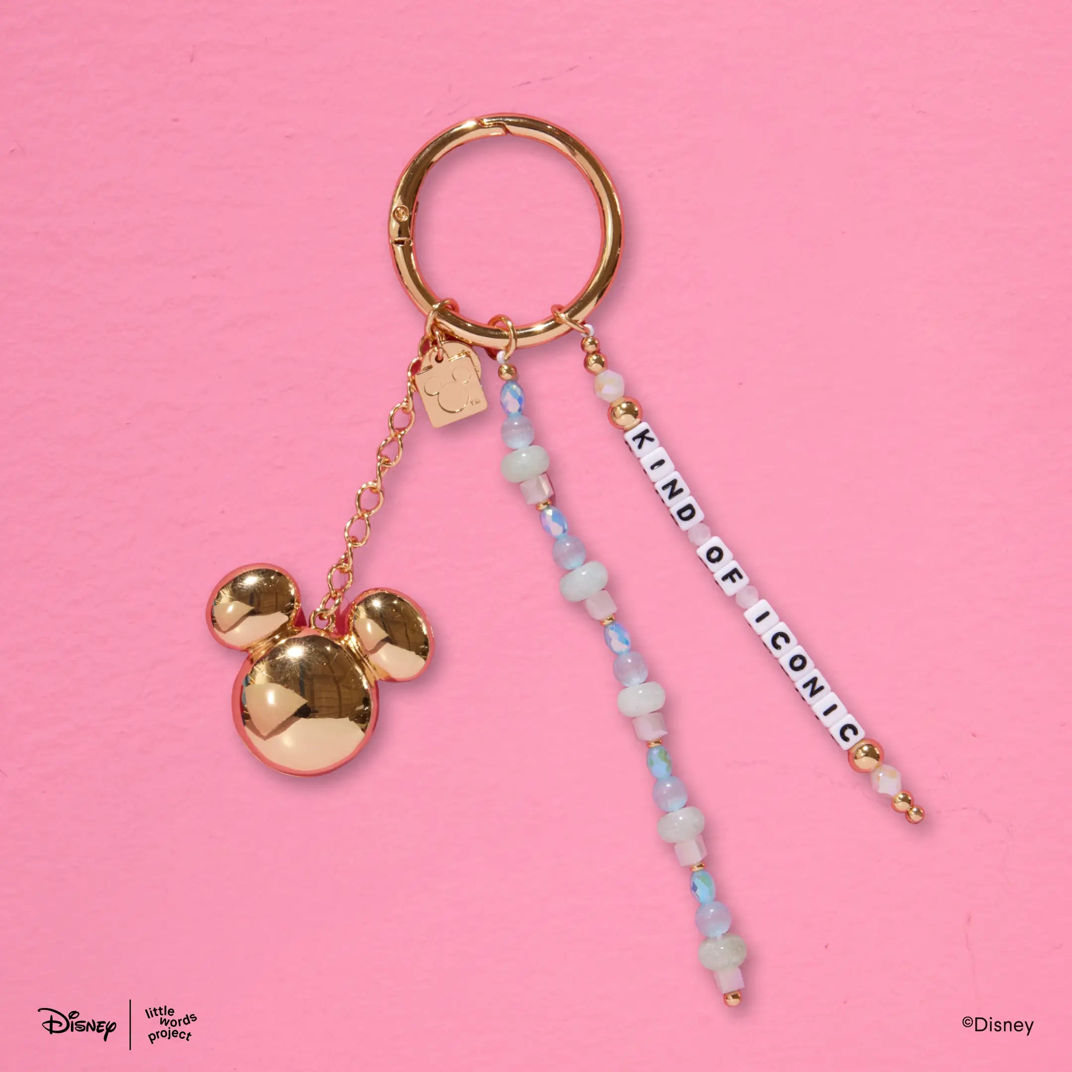 Kind of Iconic Bag Charm from Disney Mickey and Friends on pink, gold plated ring with a Mickey Mouse head charm and blue beaded letter bead strands