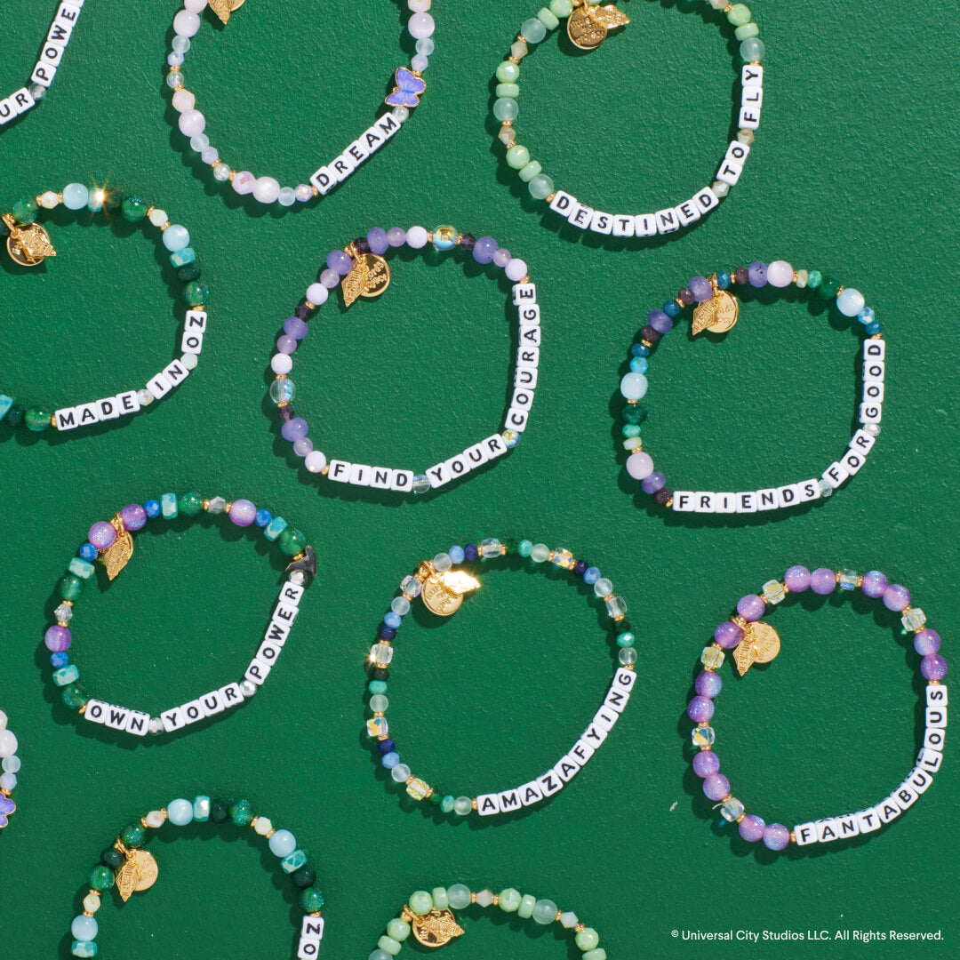 Beaded bracelets with inspirational phrases on a green background