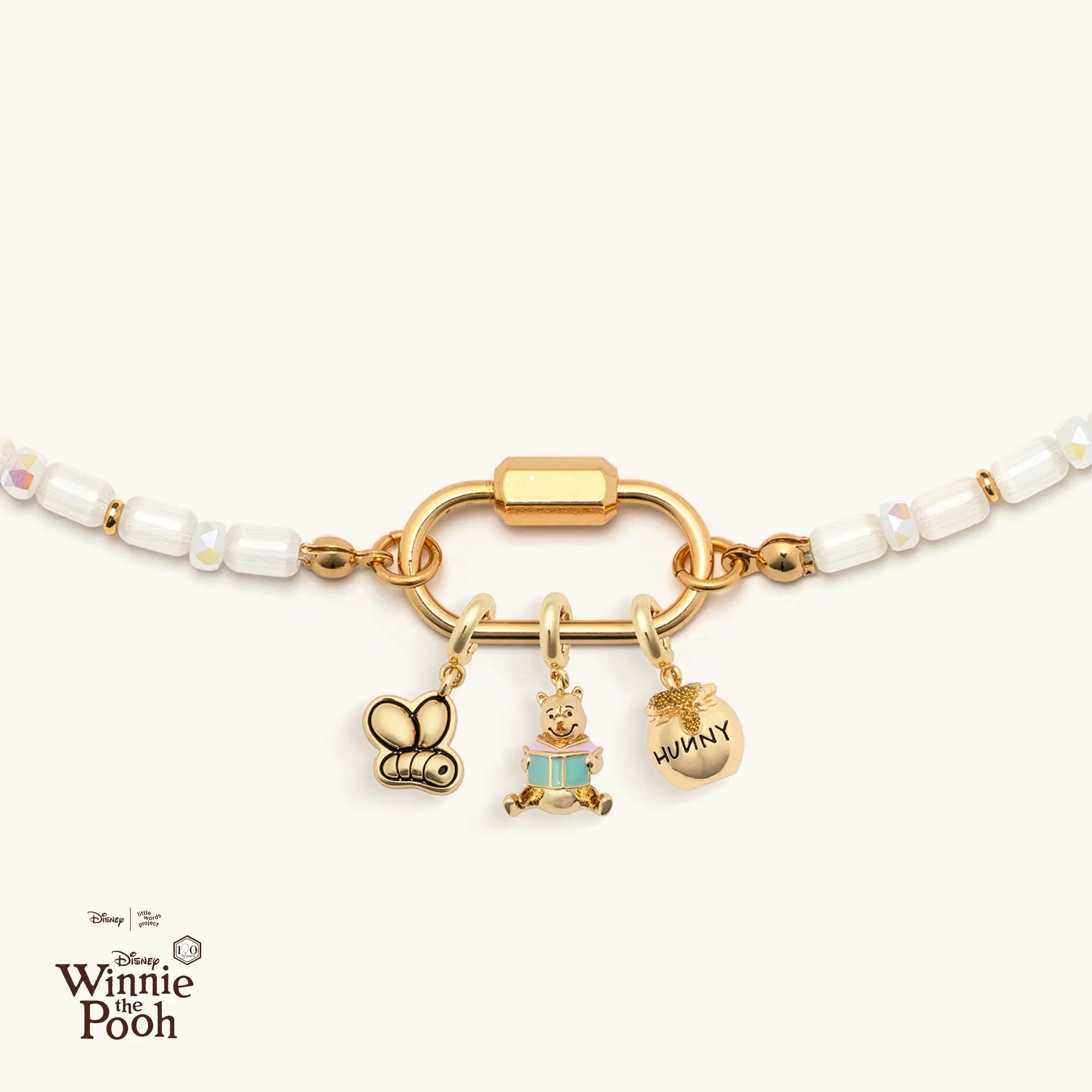 Necklace with Winnie the Pooh charms on a white background