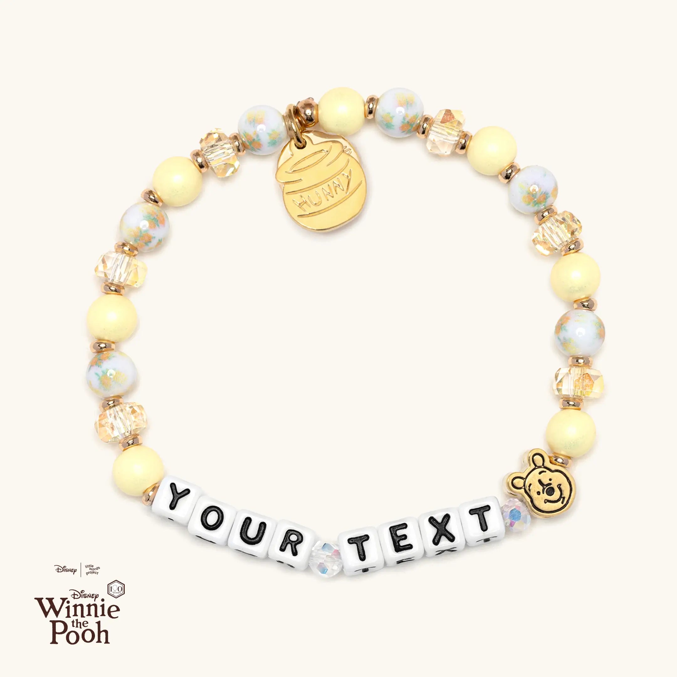 Personalized bracelet with Winnie the Pooh character casted bead on a white background
