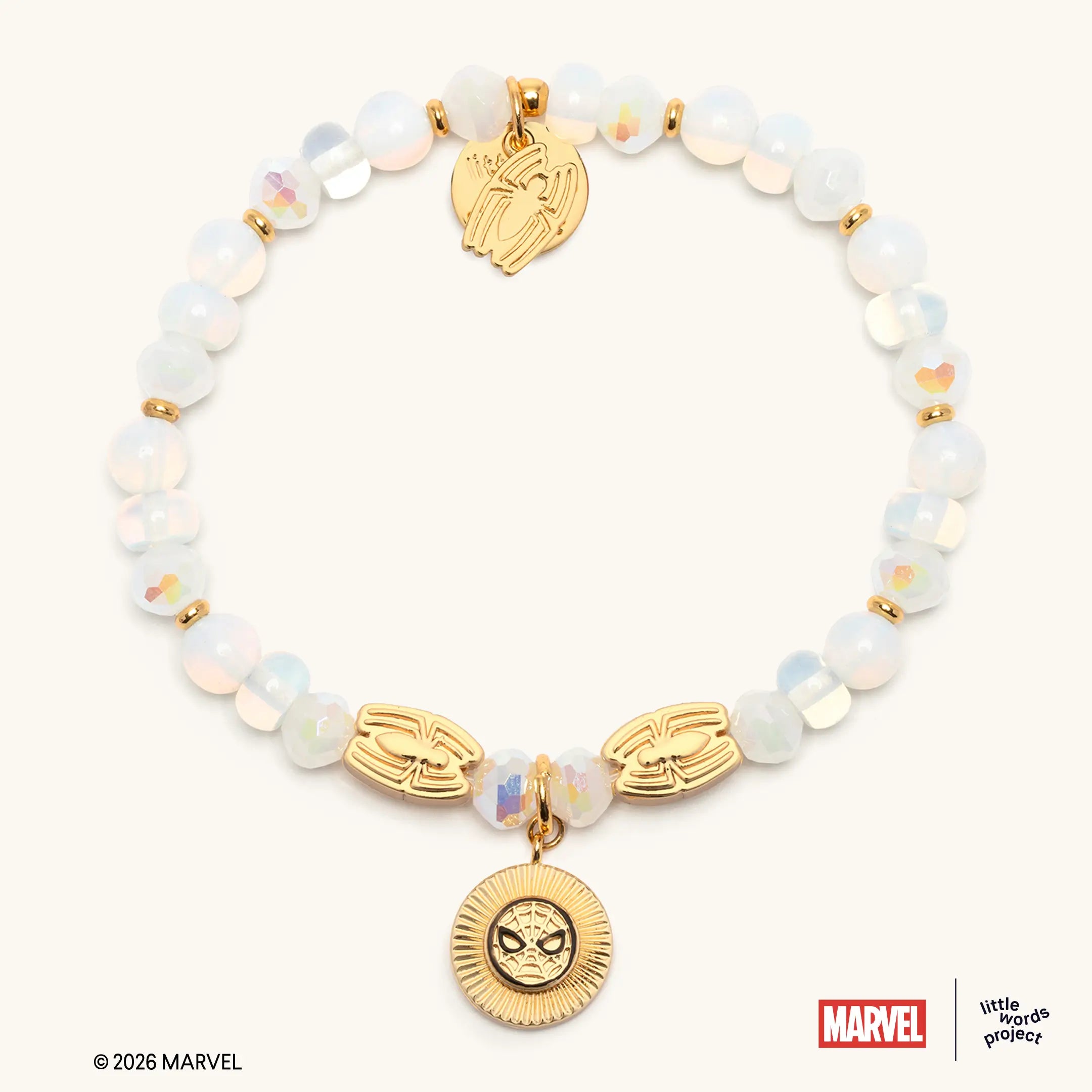 Power Brings Responsibility Bracelet Base from Marvel's Spider-Man collection, flat-lay on white background, iridescent white glass beads with gold Spider-Man eye casted beads and gold Spider-Man medallion charm