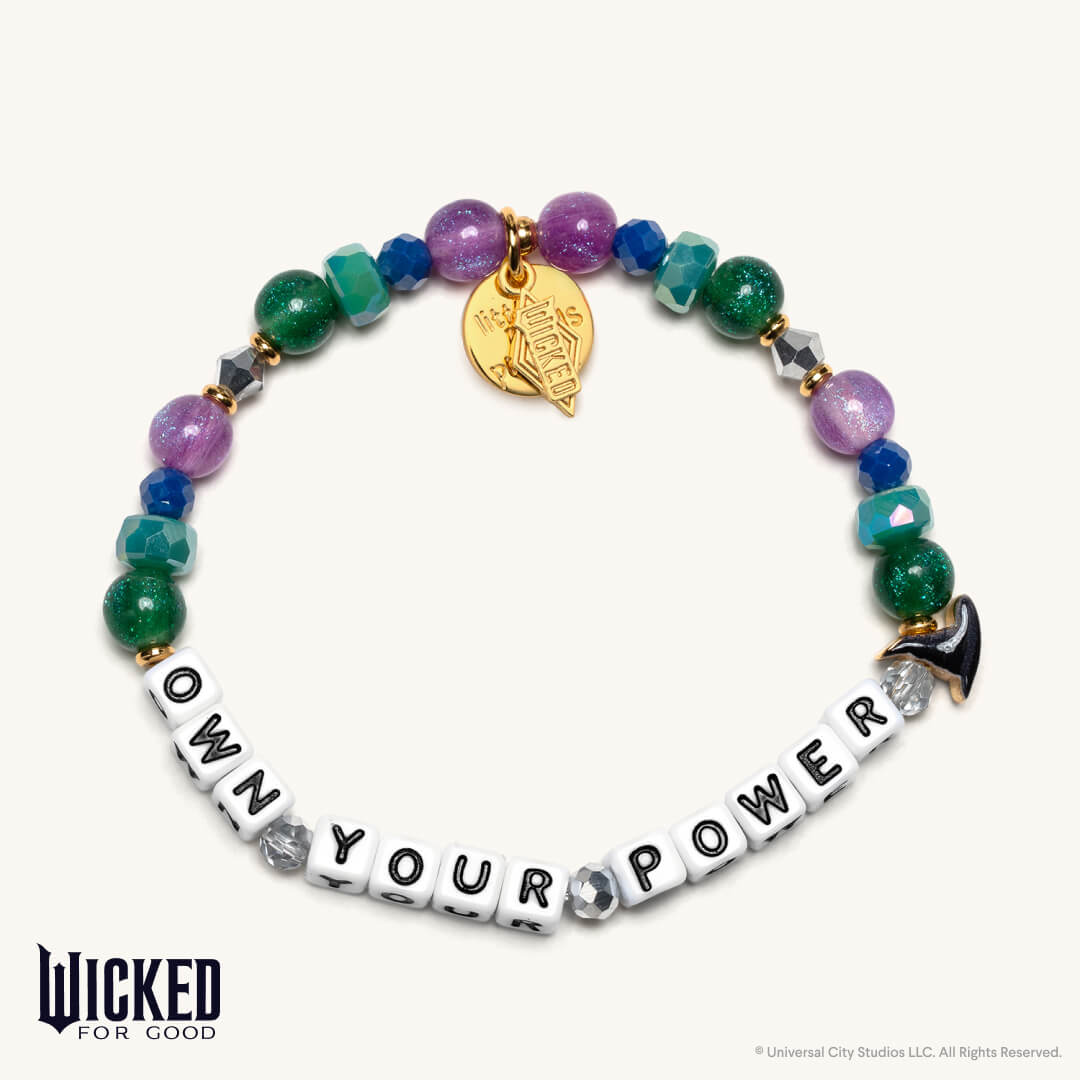Colorful beaded bracelet with 'OWN YOUR POWER' message and gold charm on a white background, featuring the brand 'Wicked for Good'.