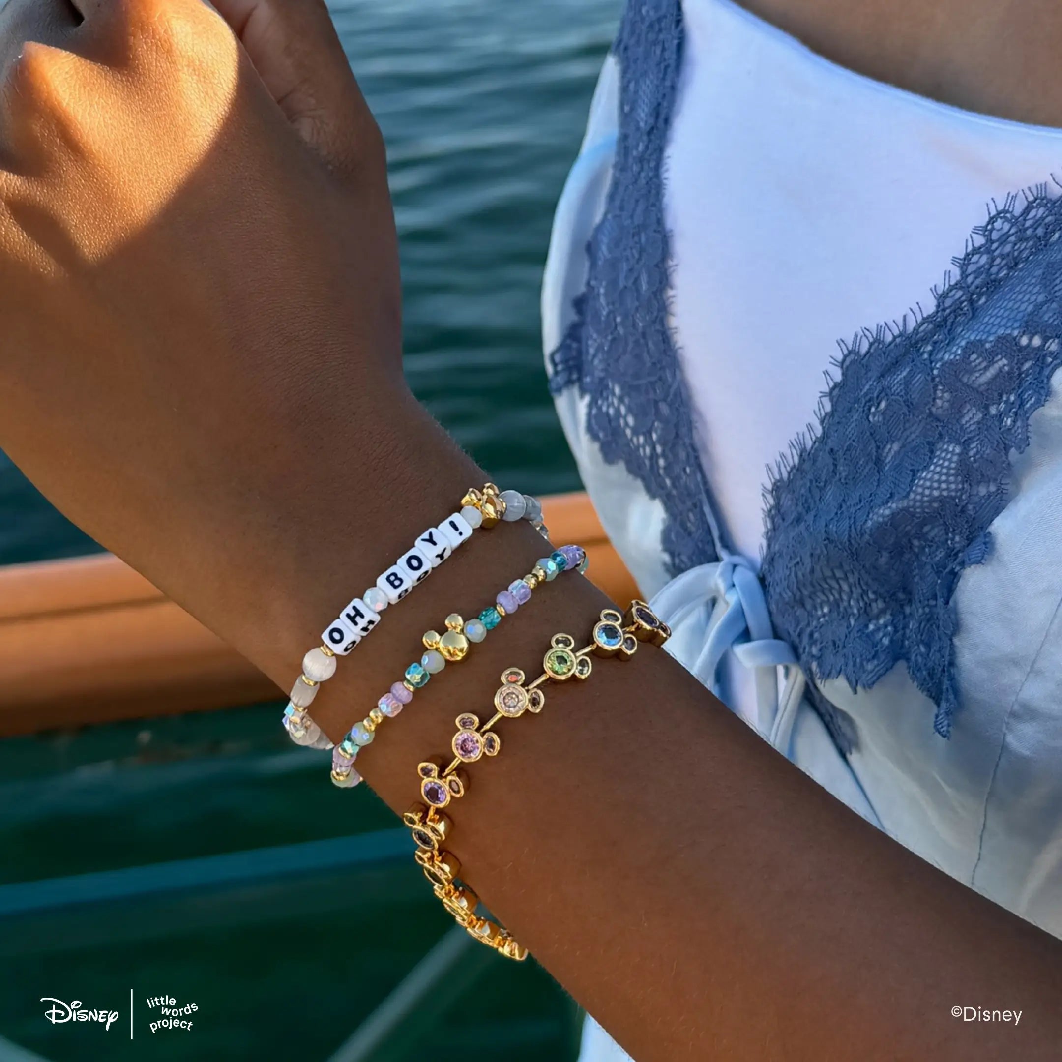 Oh Boy! Disney Mickey and Friends bracelet worn outdoors on a wrist, stacked with the gold plated Mickey Mouse Rainbow Bracelet