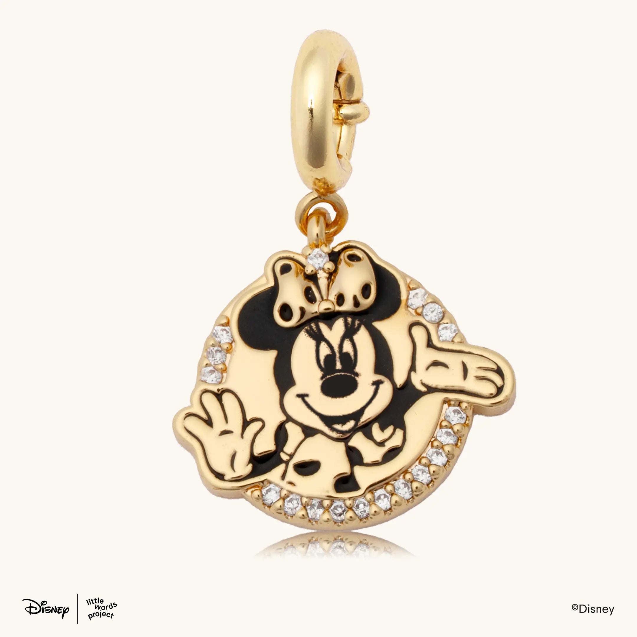 Minnie Mouse Badge Charm from Disney Mickey and Friends, gold plated round charm with a black and gold Minnie Mouse illustration and a pave crystal border