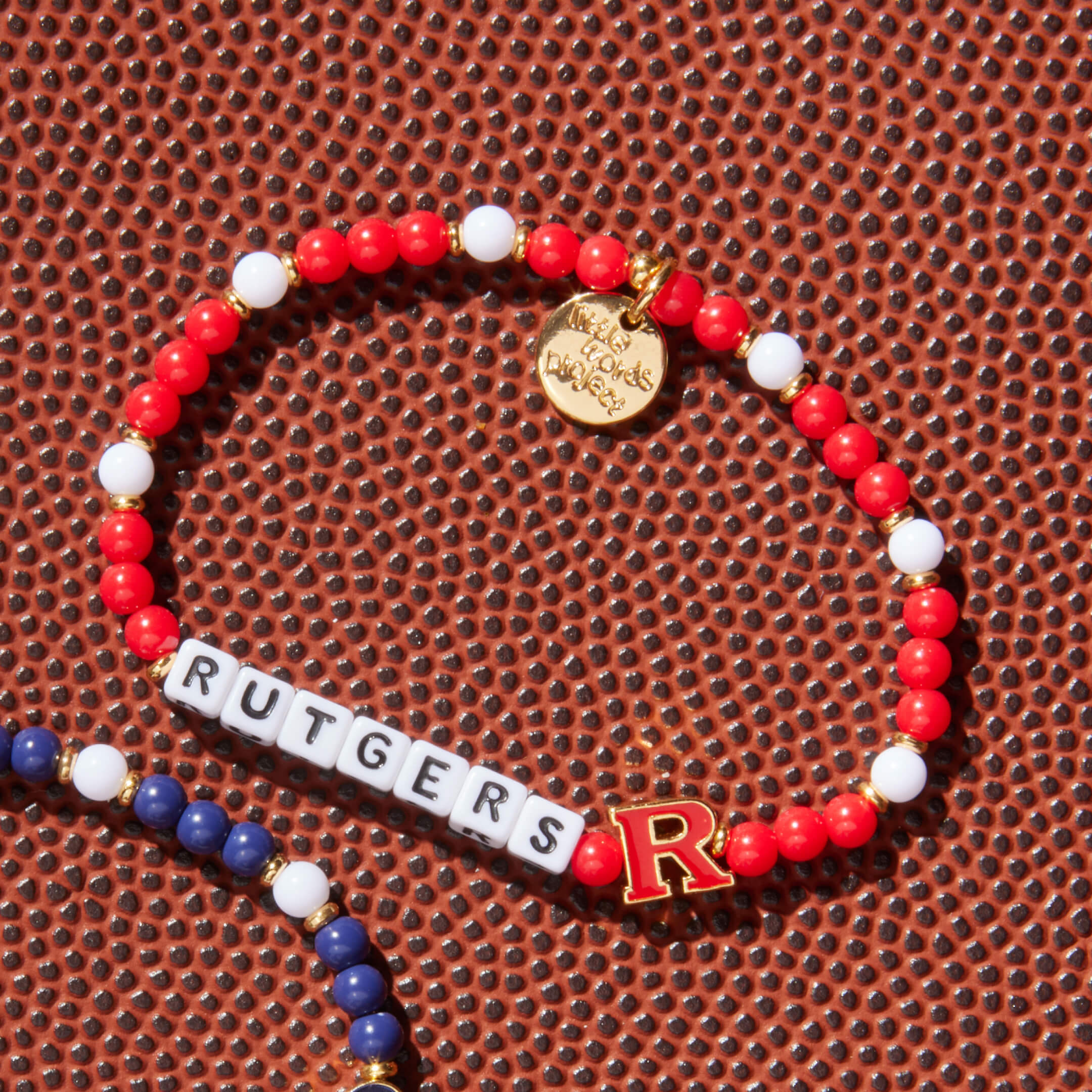 Bracelet with Rutgers letter beads on a textured surface