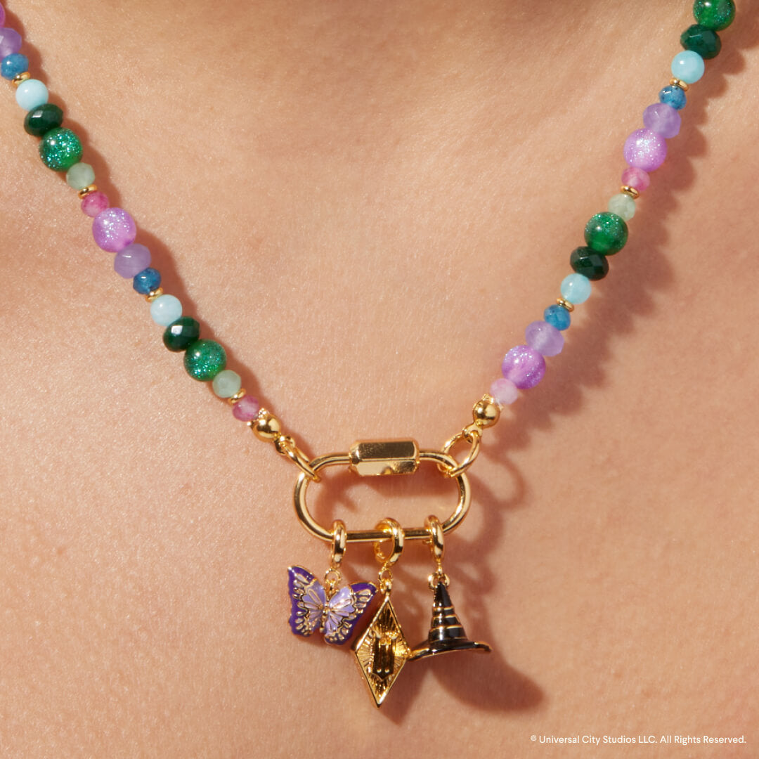 Necklace with colorful beads and gold clasp on a person's neck