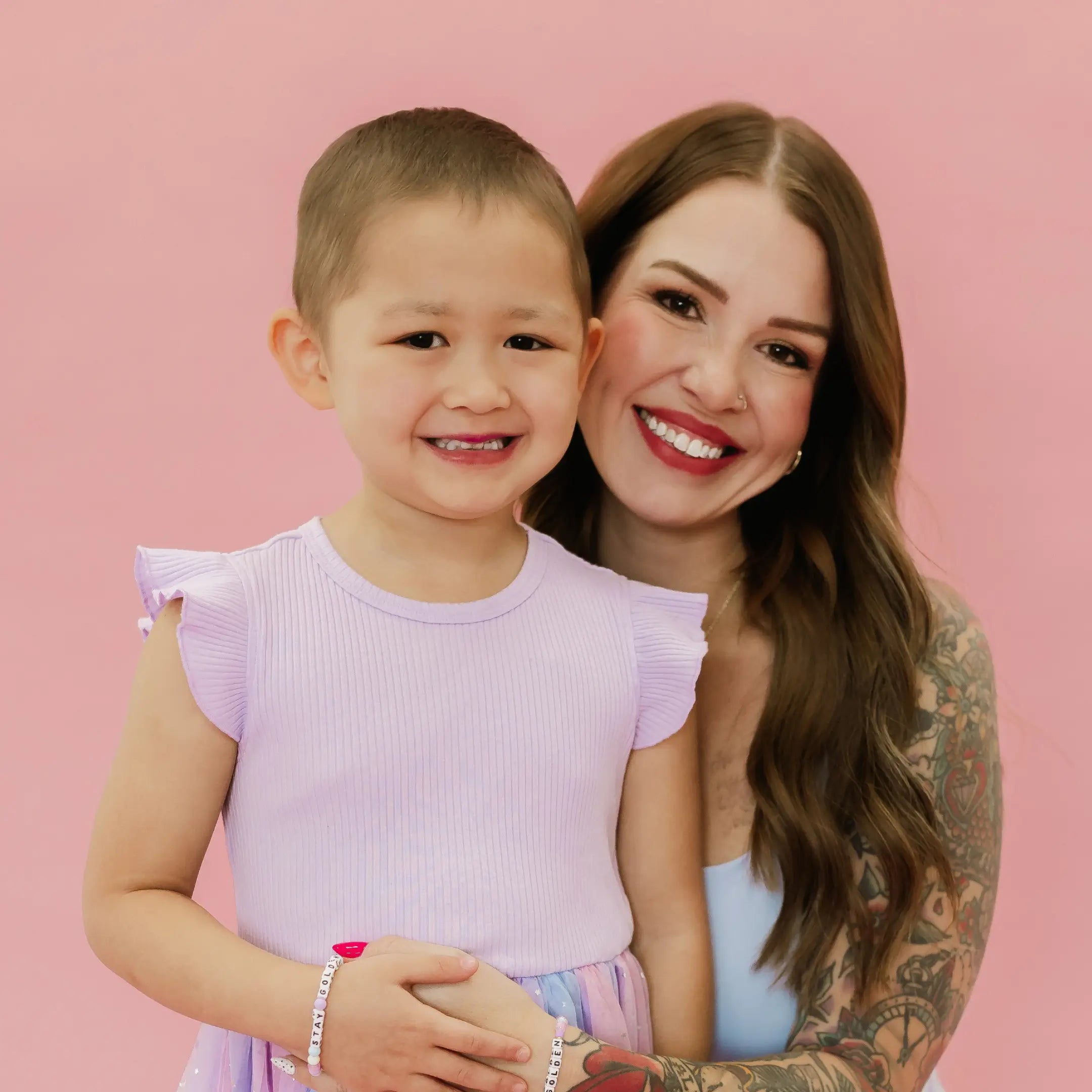 Rylee Ta and her mom smiling in matching lavender outfits wearing Stay Golden bracelets, Little Words Project Kindfluencer collection