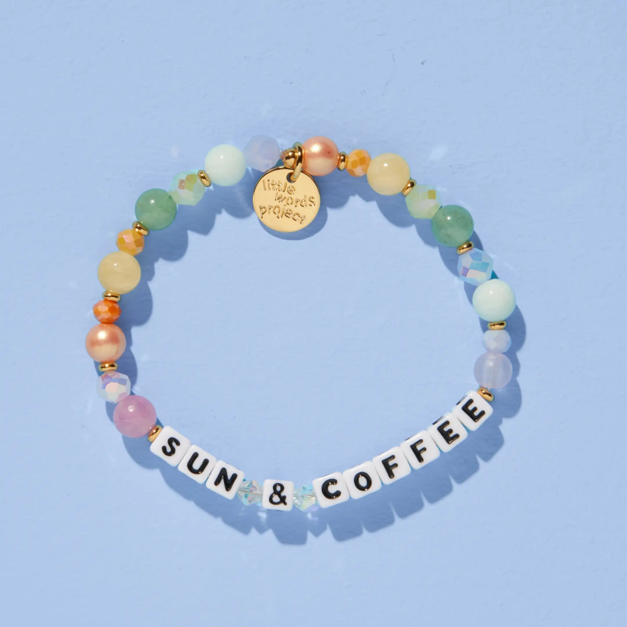 Sun & Coffee — on-model shot of beaded word bracelet stacked on wrist