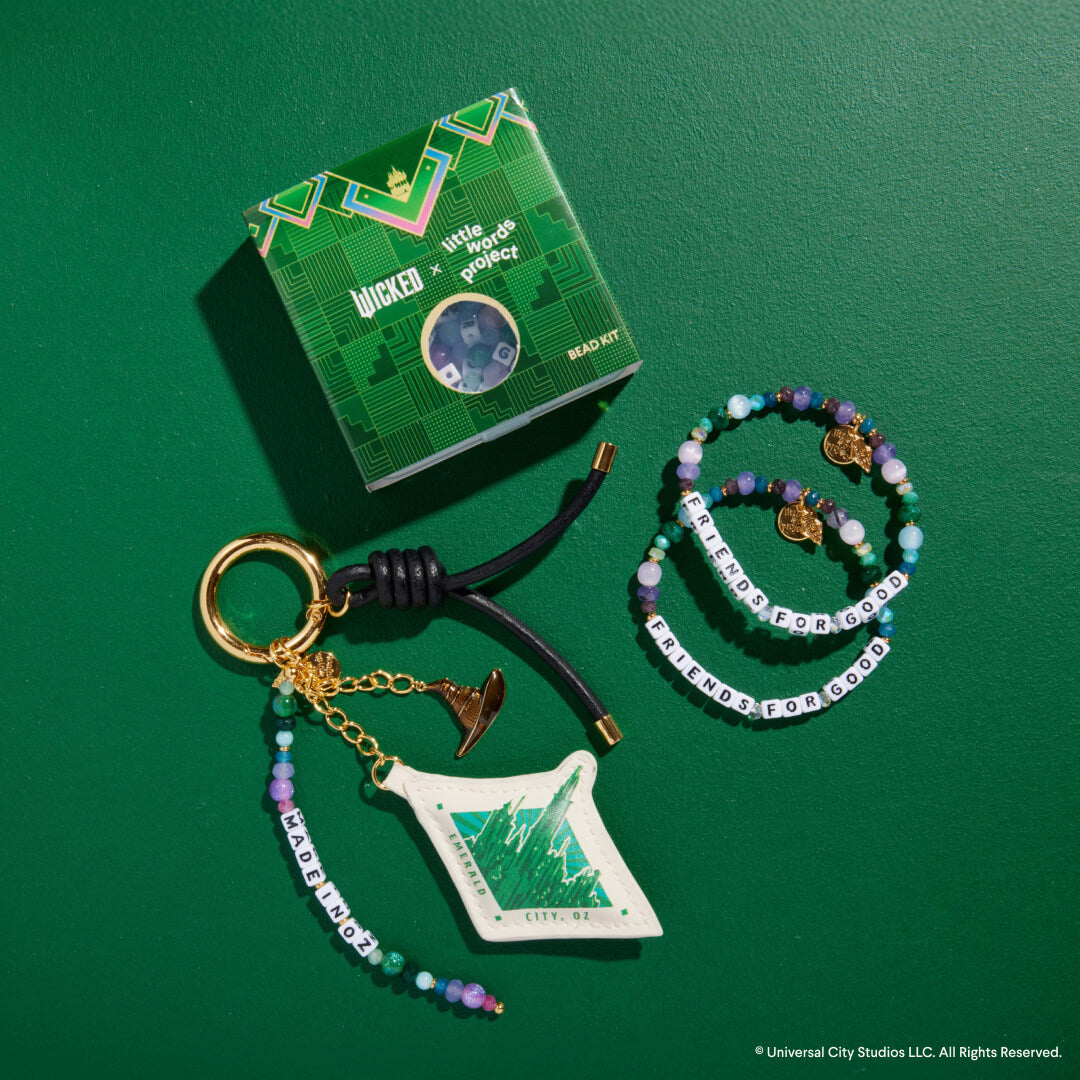 Keychain, bracelet, and packaging on a green background