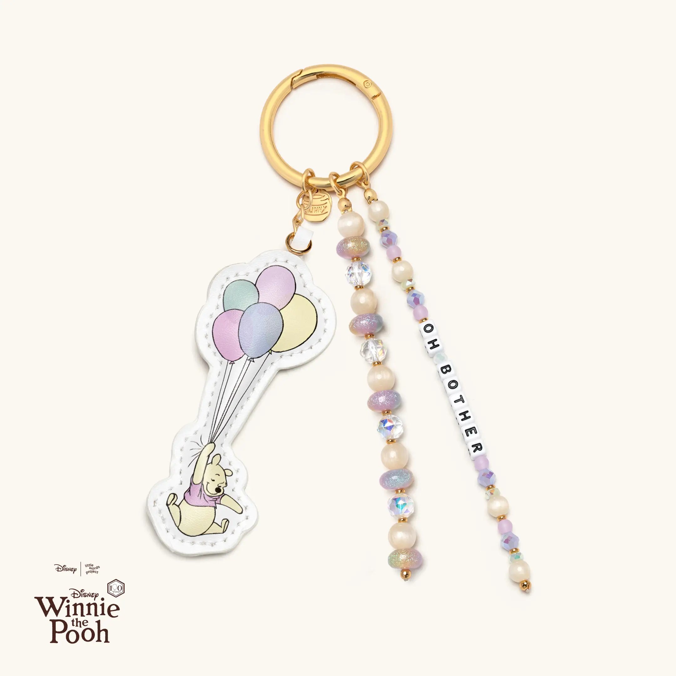 Bag charm with Winnie the Pooh holding balloons and "Oh Bother" word.