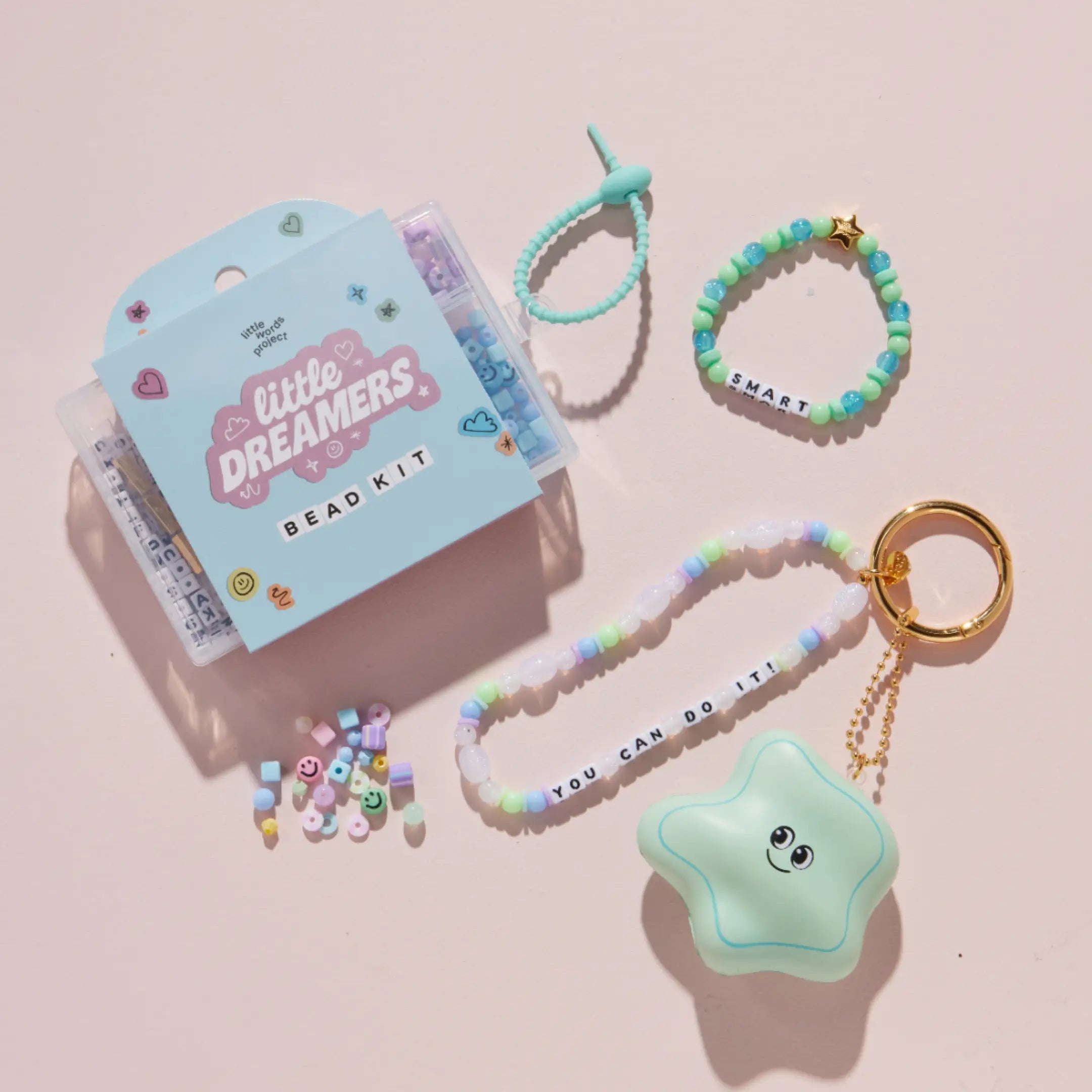 Bead kit with accessories on a pink background