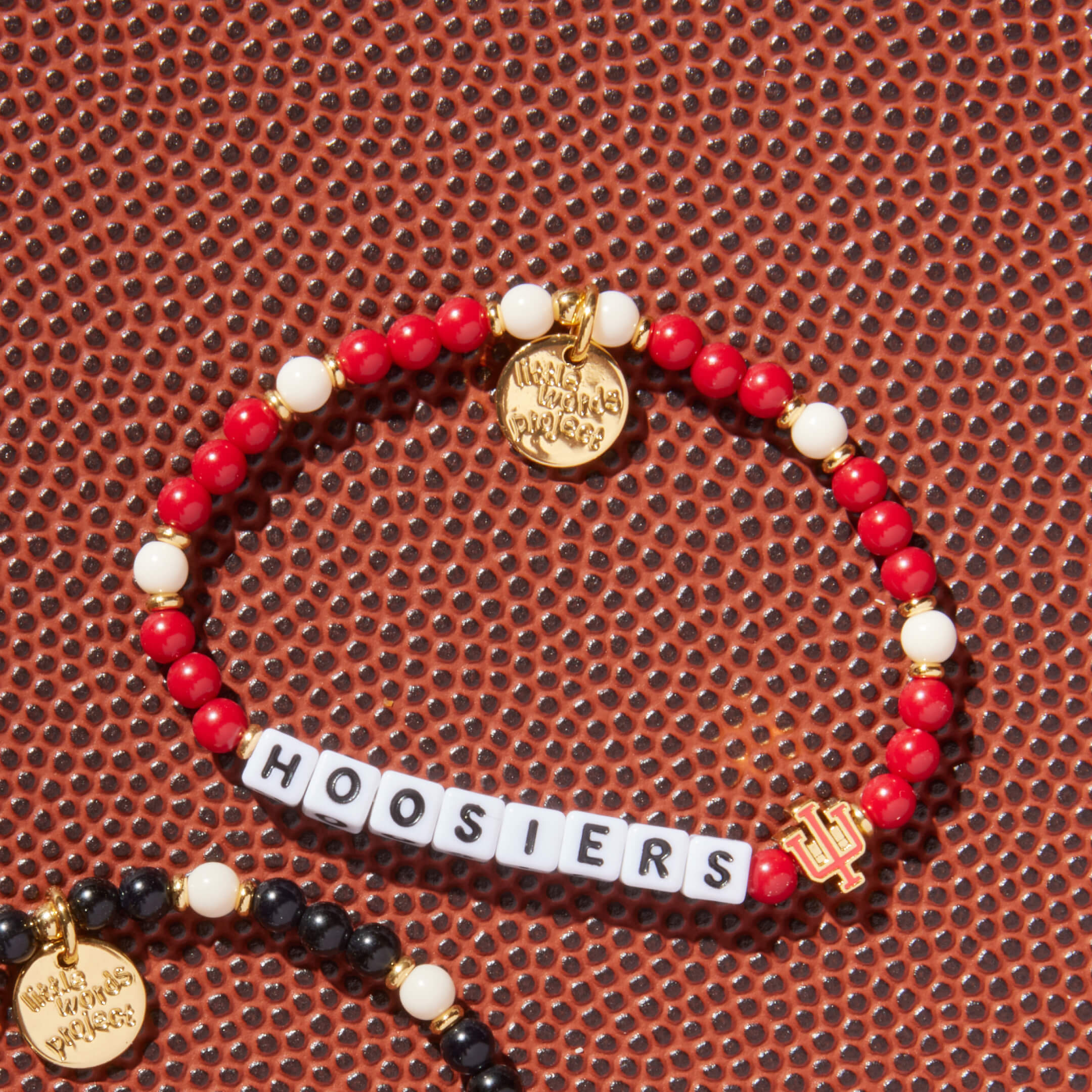 Bracelet with 'HOOSIERS' beads on a textured brown surface