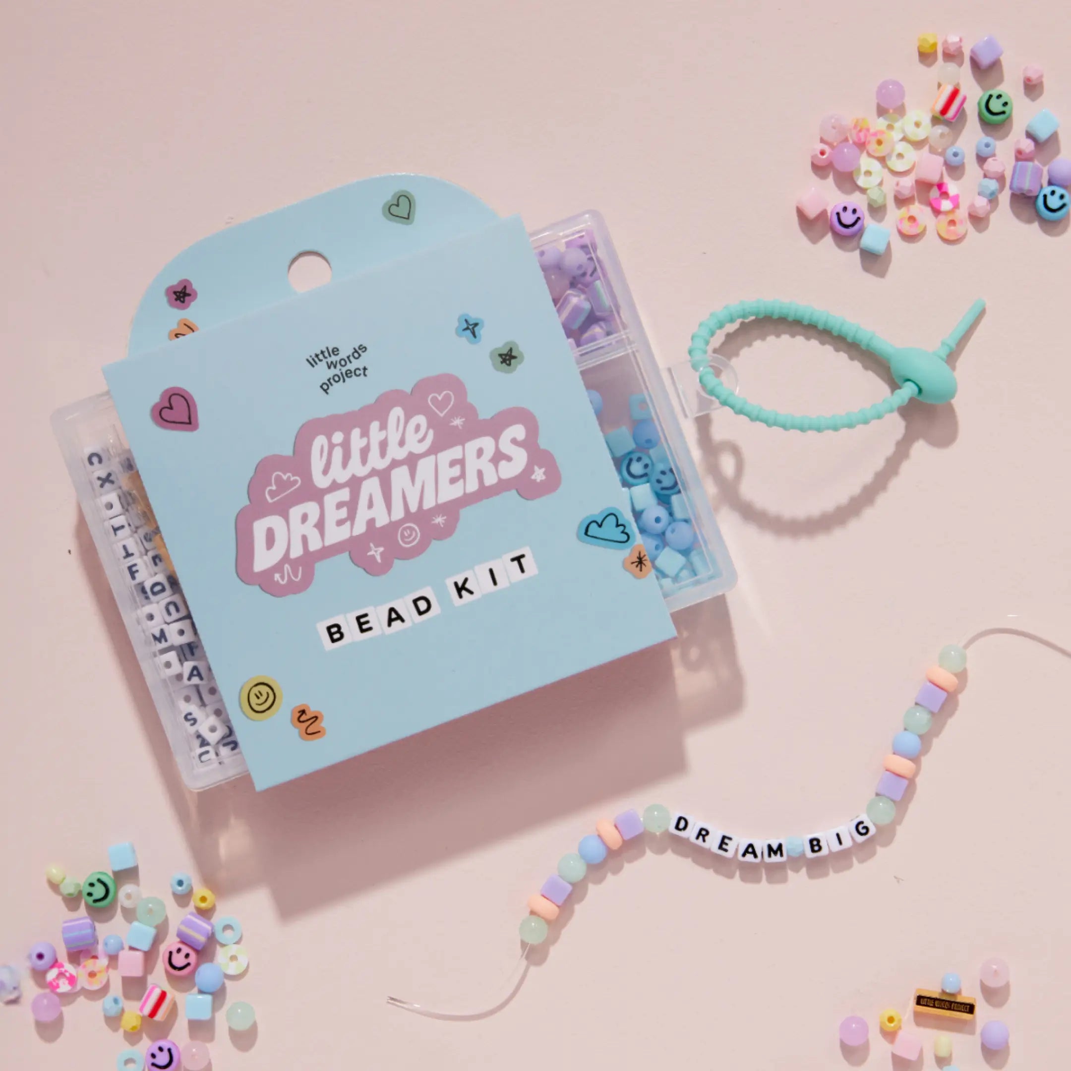 Little Dreamers bead kit with beads and a bracelet on a pink background