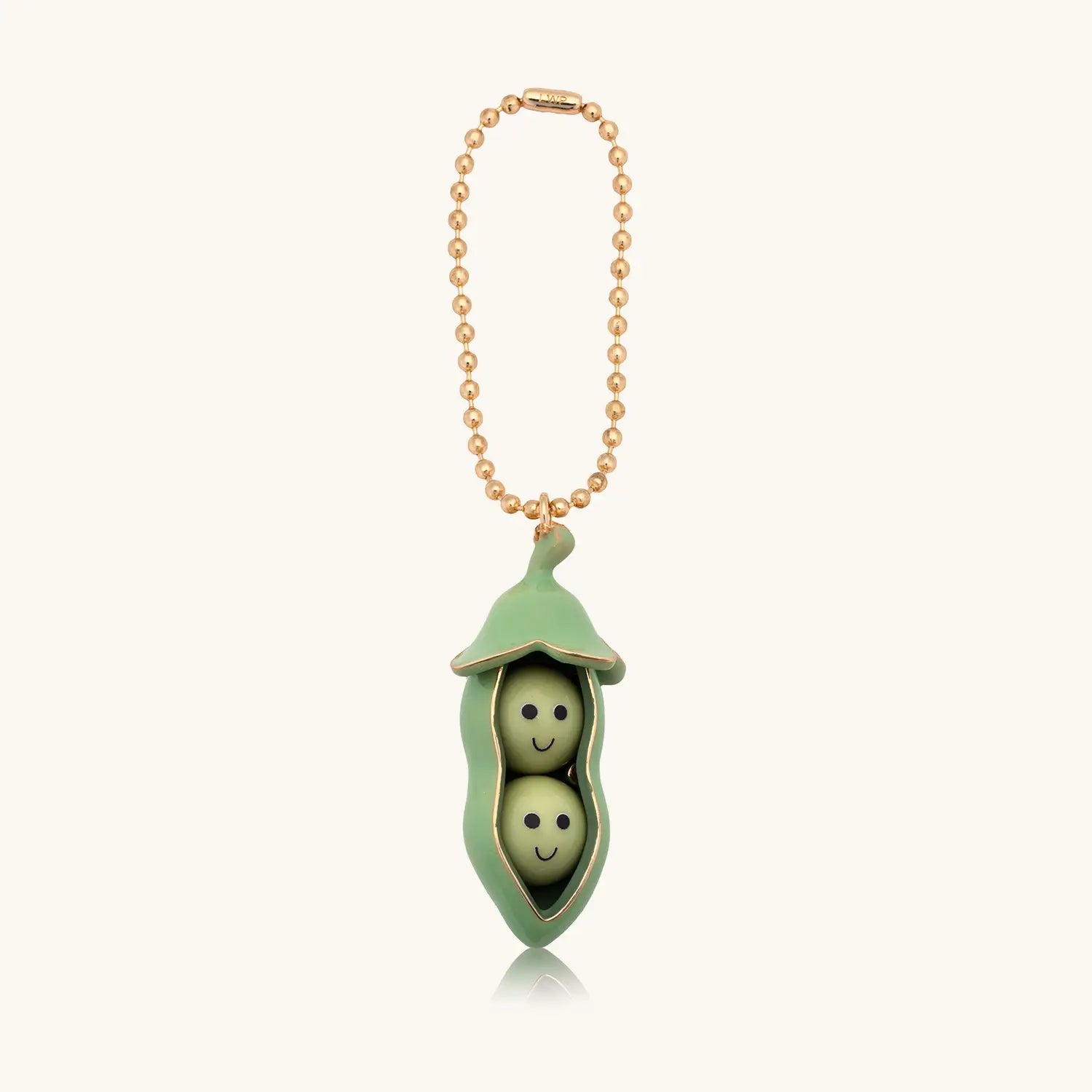 Keychain with two smiling peas in a green pod on a white background
