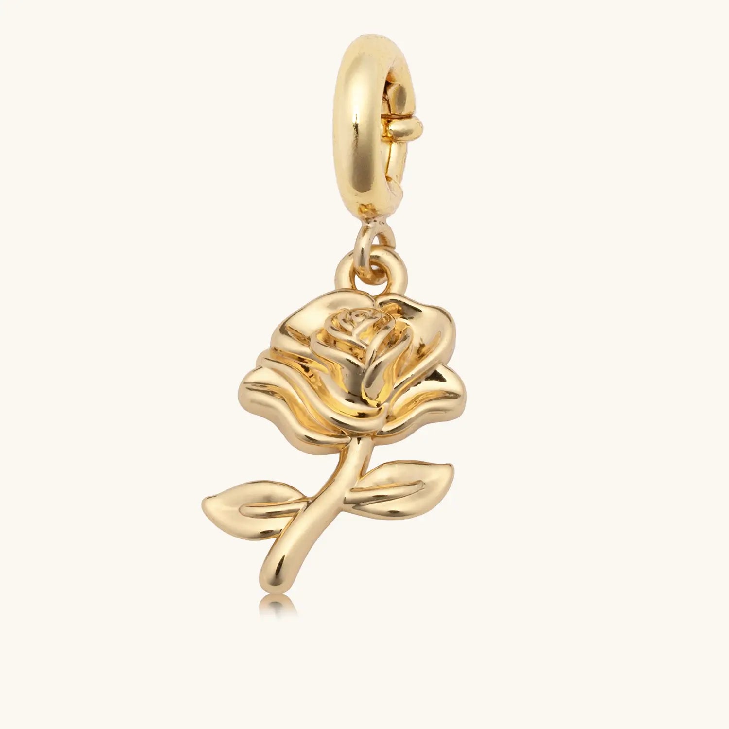 Gold rose charm on a white background