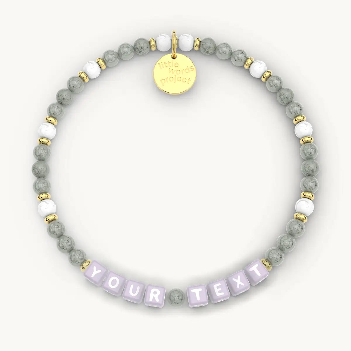 Beaded bracelet with a gold tag and customizable text on a white background