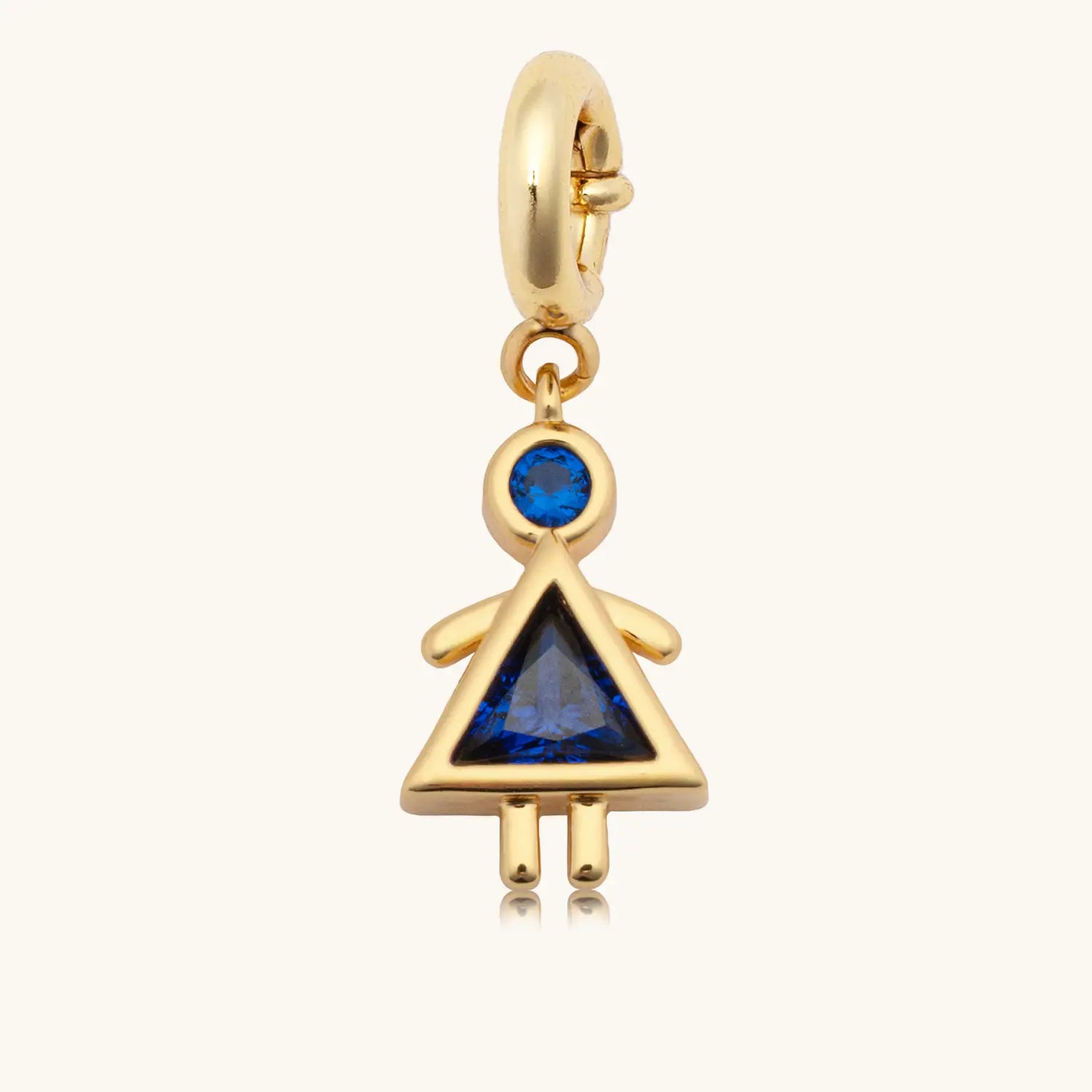 Charm with a blue gem body and girl in a dress shape against a white background