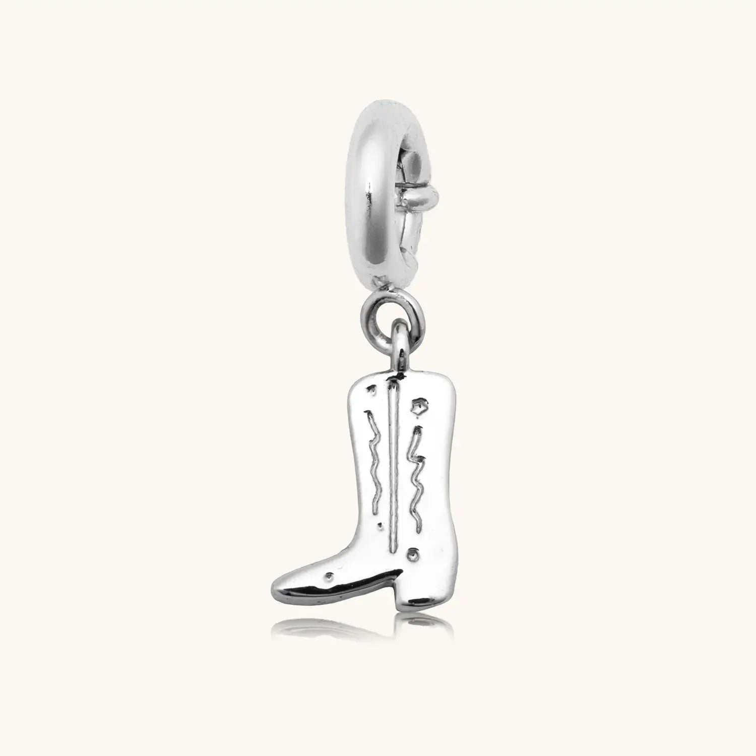 Silver cowboy boot charm pendant with engraved detailing and a spring-ring clasp, shown on a white background.