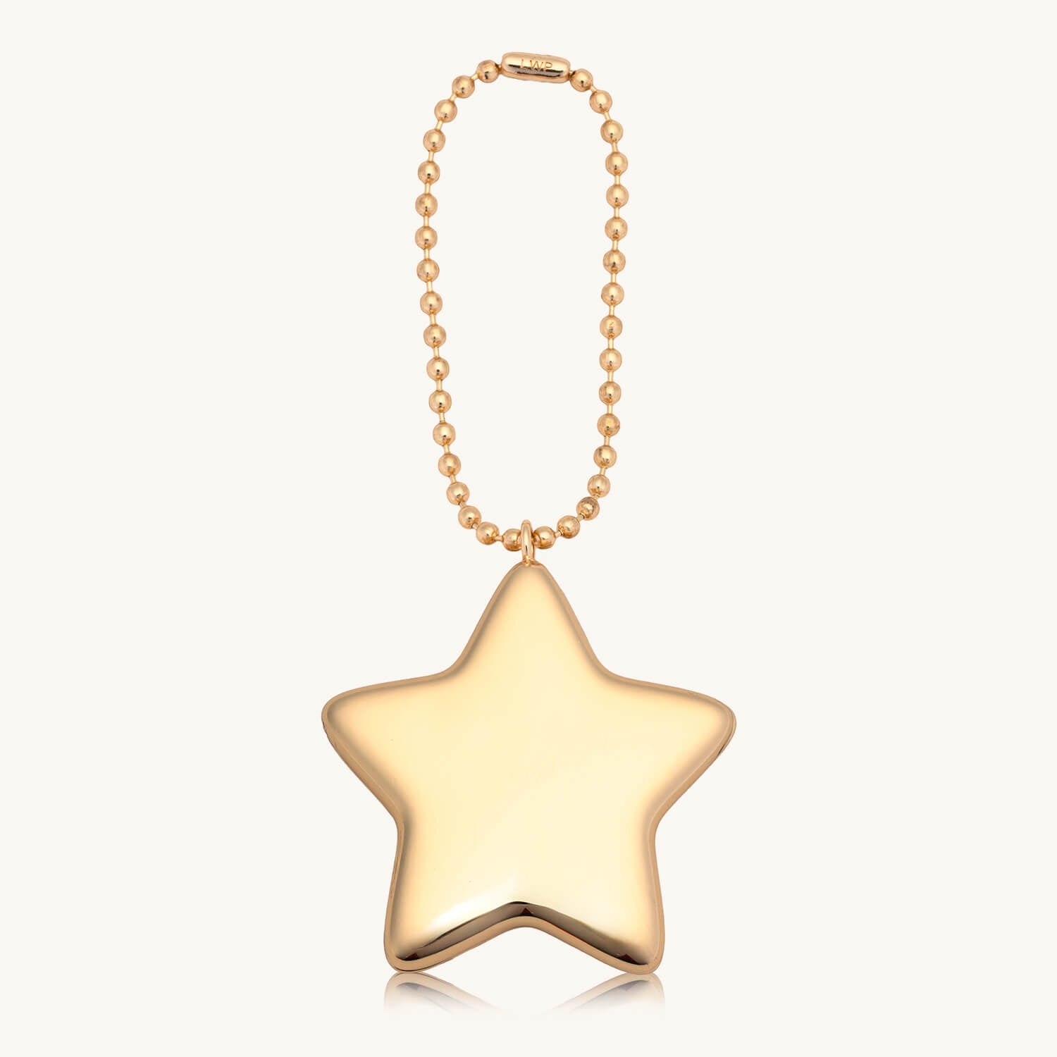 Gold star-shaped bag chain against a white background