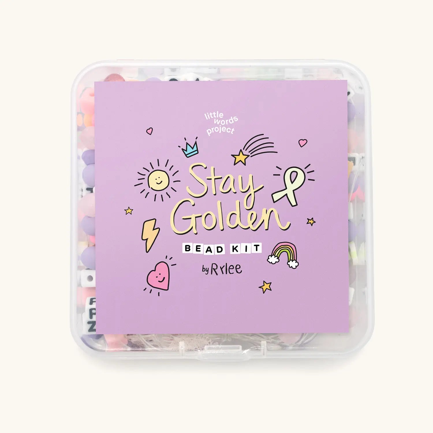 Stay Golden Bead Kit Rylee Ta front view showing purple lid with Stay Golden hand-drawn artwork and pastel beads inside the clear case