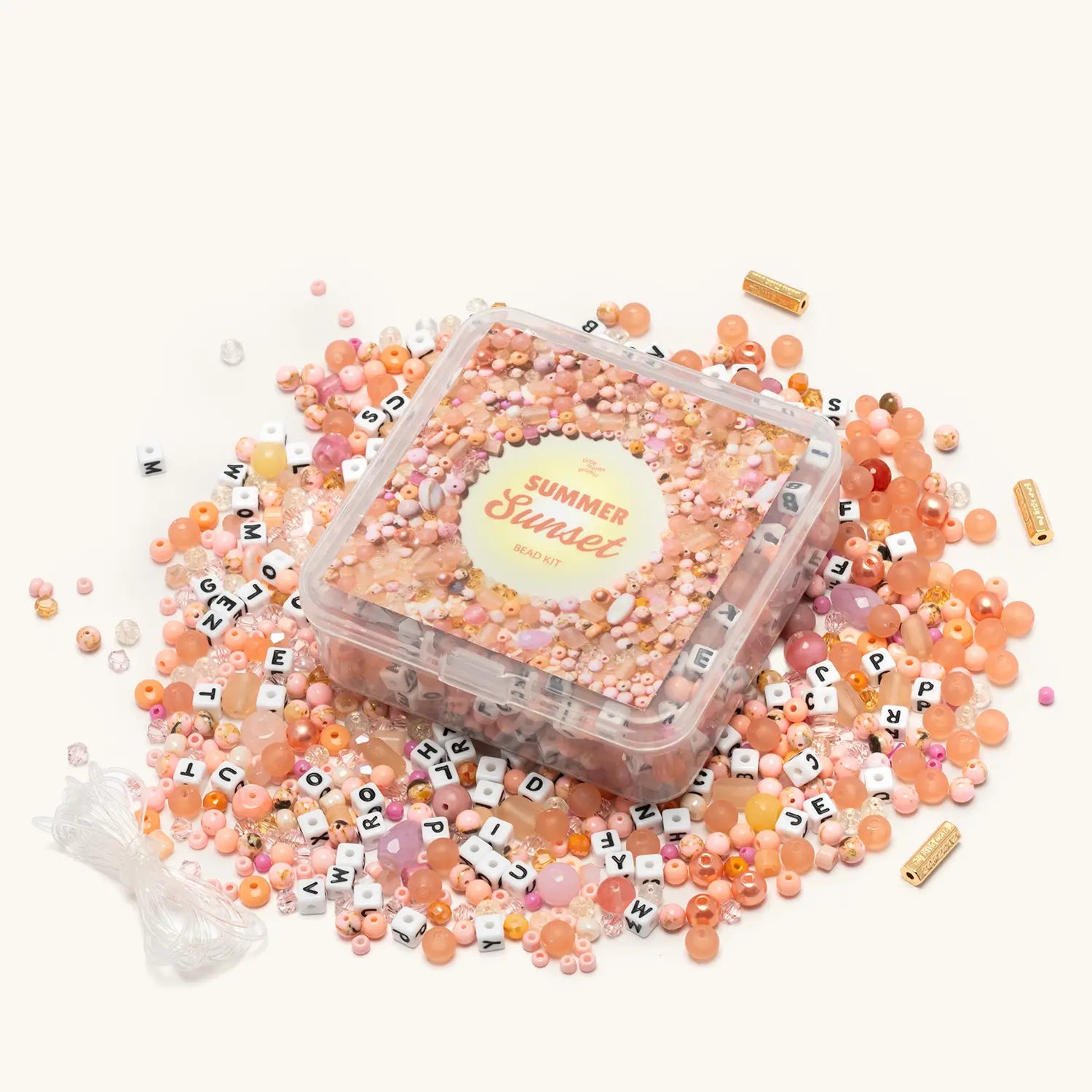 Summer Sunset Bead Kit — flat-lay of loose beads in warm coral, orange, and golden tones