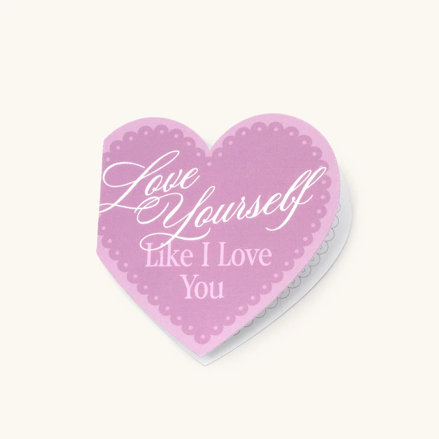 Heart-shaped pink card with 'Love yourself like I love you' text on a white background