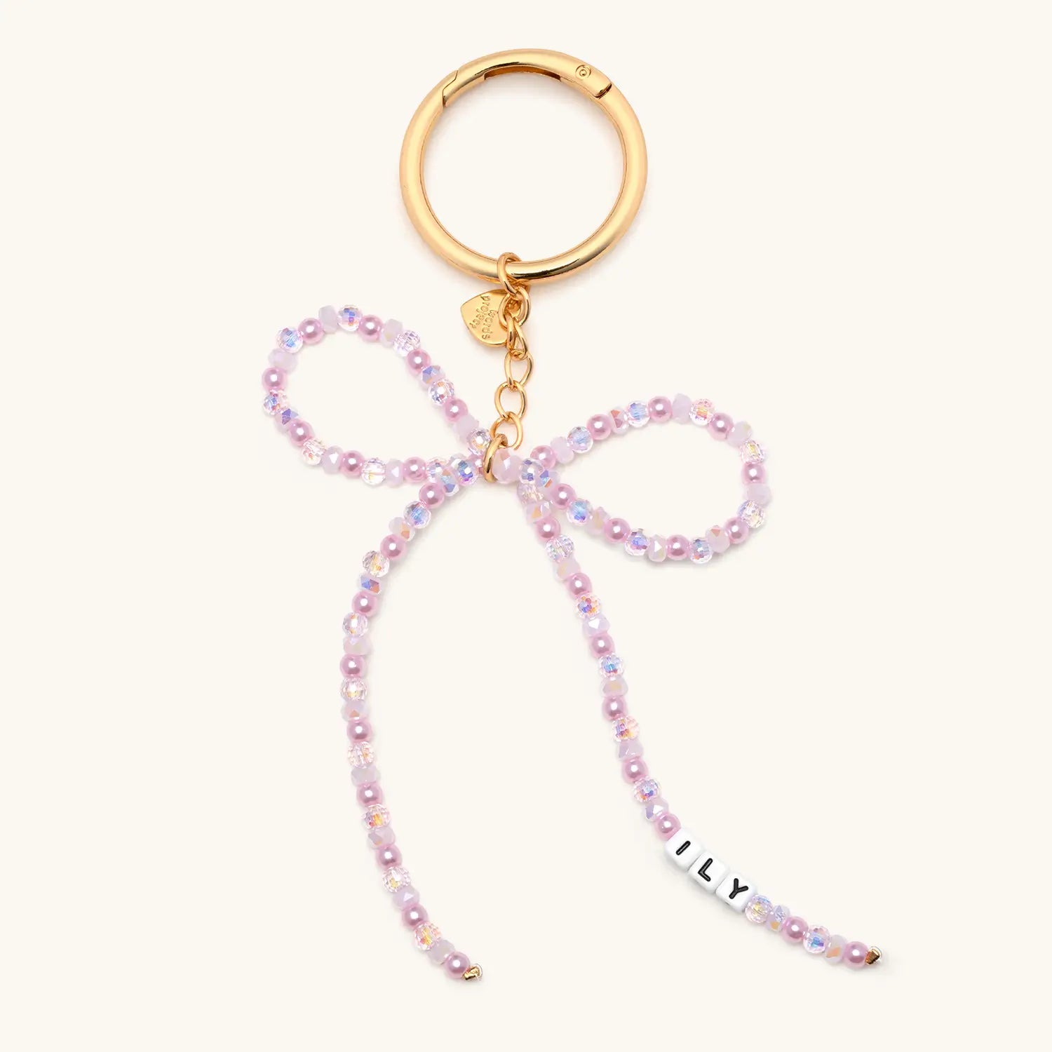 Keychain with pink beaded lanyard and gold clasp on a white background