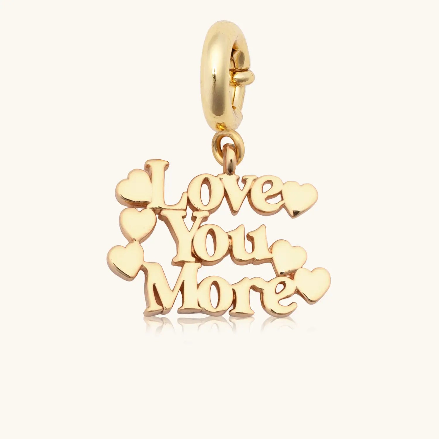 Gold charm with 'Love You More' text on a white background