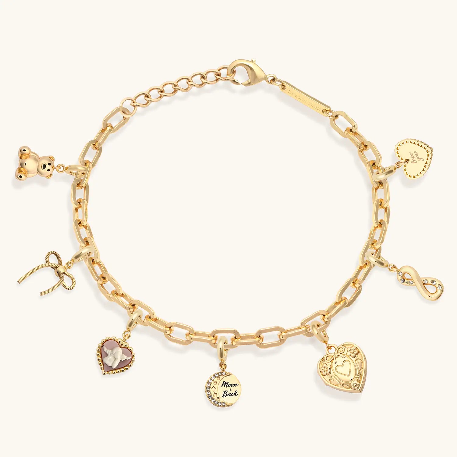 Gold charm bracelet with various charms on a white background