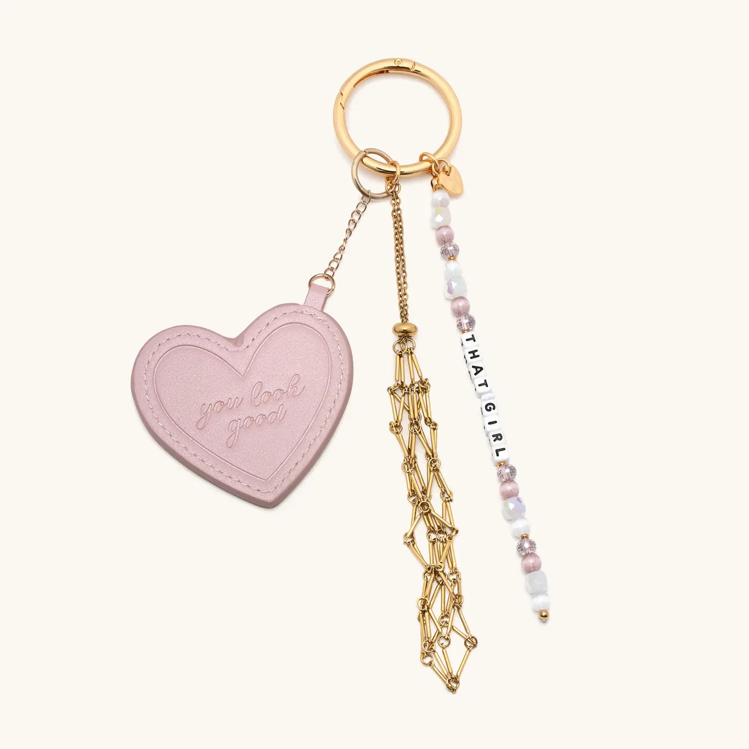 Heart-shaped keychain with gold chain and beaded charm on a white background