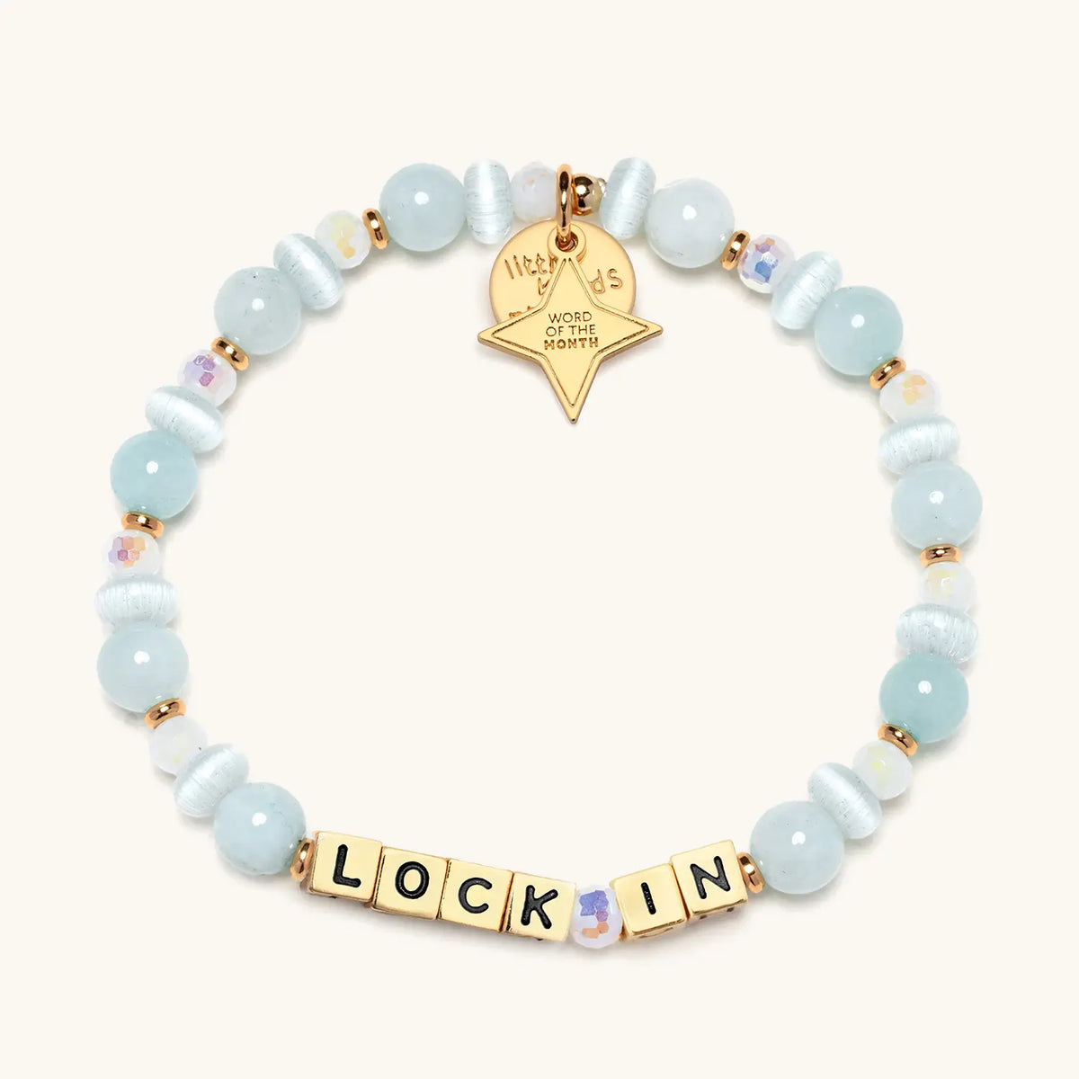 Lock In bracelet with light blue beads and gold letter beads, from the Six Months of Intention set