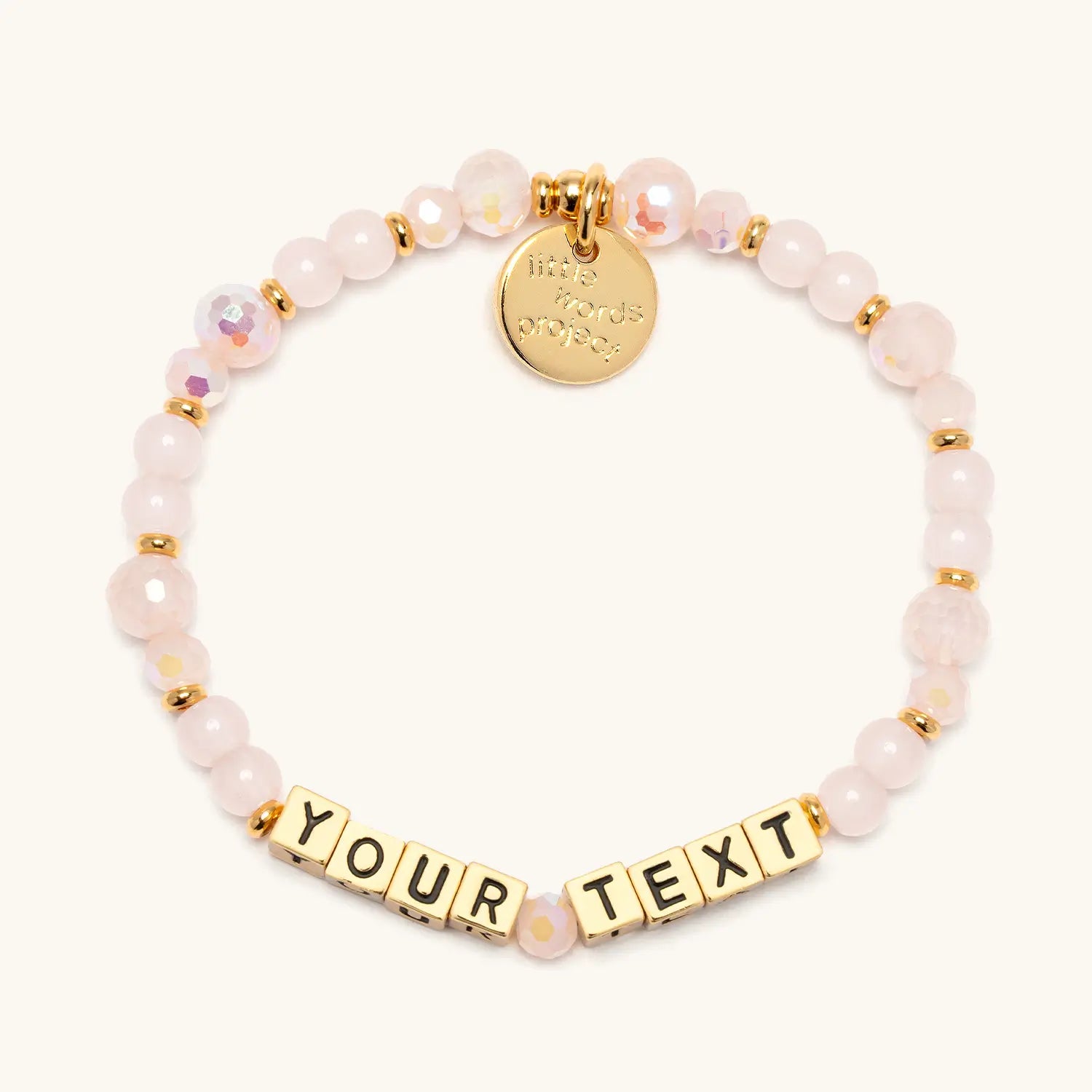Custom Sweetums bracelet with soft pink crystal and glass beads and gold letter beads reading Your Text