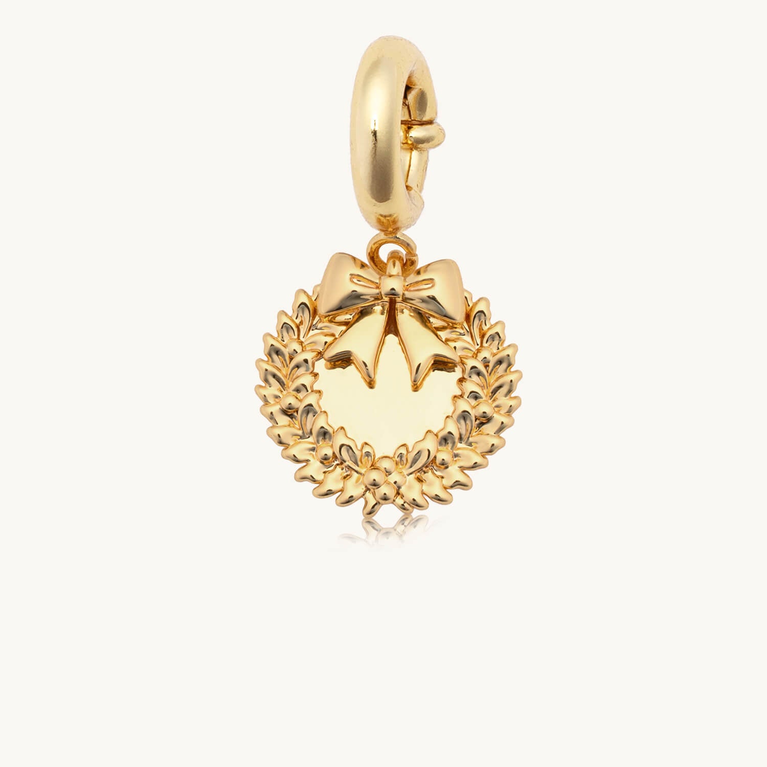 Gold wreath charm on a white background